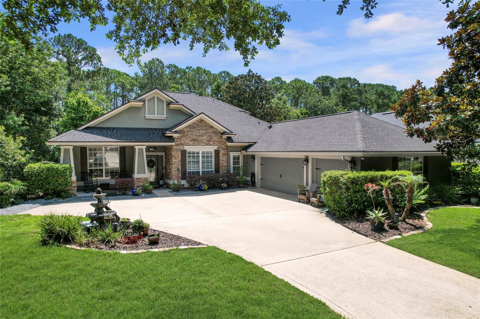Presenting 198 Parkside Drive in Palencia, built and designed by Richard R. Dostie, this Craftsman style home has over 2,900 square feet and is perfectly located on over a quarter acre that backs up to the neighborhood preserve. The Royal Vilano floor plan is ideal for those who like to entertain friends and family, with a large, upgraded kitchen that looks out over the living room and a separate den / office space that's great for family movie night. The expansive first floor master suite has wonderful backyard views, walk-in closet, his / her sinks, and a walk-in shower with separate tub. The first floor also includes 3 other guest bedrooms, 3 full bathrooms, laundry area, and a 3-car garage. Upstairs you'll find a large 19x13 fifth bedroom and another full bathroom, a perfect space to use as a guest suite. The exterior of the home has covered front and back porches, and lots of privacy in the backyard with plenty of room for a pool. The Palencia community was designed with nature in mind and has lots of walking trails, boardwalks, and sidewalks in the shade of beautiful North Florida hard woods. There is a plethora of resort style amenities afforded to community residents which include; a fitness center, aerobics room, playgrounds, pools, security gate, tennis, and pickleball. This is North Florida living at its finest.