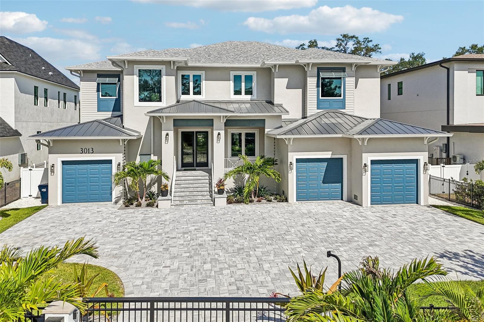BRAND NEW luxury home located in a newly developed area of privately gated estate homes on a rare 0.40-ACRE LOT. Constructed by the well-respected builder, Kingfisher Development, this home is a fortress built with solid block construction, impact rated doors and windows situated on one the largest lots you will find offering you a beautiful private and QUIET oversized backyard.  Step through the double doors into the oversized foyer with 22 ft ceilings and attractive cable railing staircase and you will immediately notice how this home is flooded with natural light and designed with a transitional style that will fit any décor.  The front living room has beautiful ceiling detail, is adjacent to the glass enclosed wine room and dry bar and could be used as a formal dining room if that is your preference.  Adjacent to the living room is the home office/den with an attention getting custom accent wall. The spacious great room is open to the eat-in kitchen with a Wolf gas range, paneled front SubZero refrigerator, walk-in pantry and custom designed two-toned wood cabinetry with attractive brass hardware.  The floor plan includes a private guest bedroom suite on the first floor with the primary bedroom located on the second floor along with 3 additional bedrooms (all with ensuite baths), a large bonus room with wet bar and built in shelves PLUS an additional bonus room that could be used as an office/nursery/craft room, additional master closet space or easily accessible air-conditioned storage. There are large laundry rooms on both floors for your convenience.  You will want to spend as much time outside as inside on the oversized back tranquil covered lanai enhanced with Bahama shutters, stained wood ceilings and travertine flooring. This space has been well designed to include two distinct seating areas, one where you can gather in front of the outdoor gas fireplace and upscale outdoor summer kitchen, and the other adjacent to the 10-person elevated spa. The spa overflows to the pool with a splash deck and all overlooks the oversized fully fenced and landscaped backyard. You will be safe and secure behind an electronic front gate and have ample off-street parking on the oversized front brick paver driveway.  The 4-car garage has electric car charging outlets, the entire home has been pre-wired for a whole house generator and pre-wired for all your technology, security audio/visual needs.