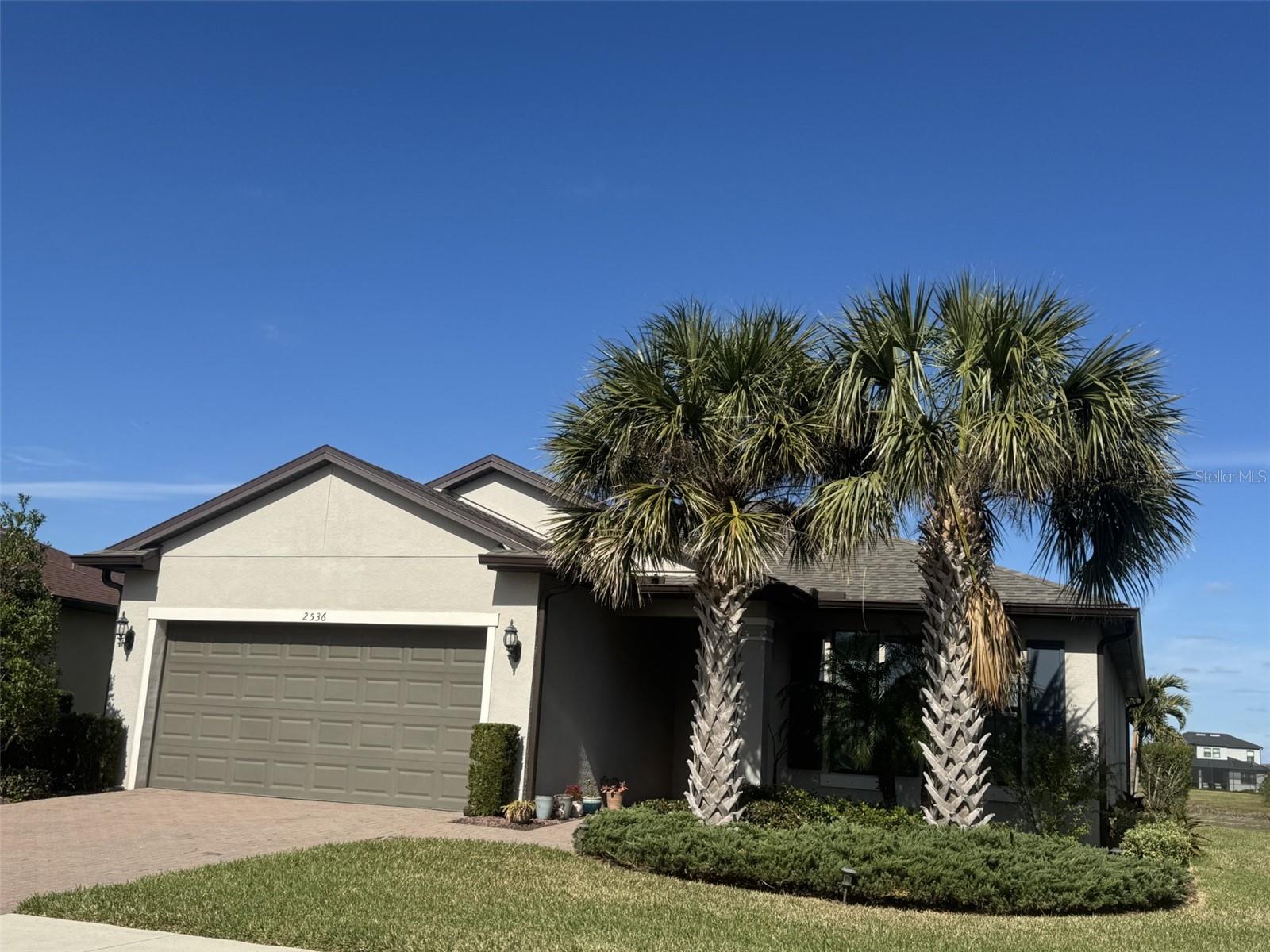 Come tour this meticulously maintained three bedroom plus flex/office/bedroom, two-bathroom home on a beautiful lot w/70’ lakefront view. This gem is located in the highly desirable, all-age community of Cedar Grove at The Woodlands with community amenities like a neighborhood heated pool, pool cabana, and HOA fee that includes lawn care. Step into an open-concept layout with vaulted ceilings and an enclosed lanai that offers stunning lake and preserve view visible from from living area and master bedroom. Room for a pool and gorgeous sunsets with an array of wildlife and birds. The gourmet kitchen is a masterpiece; featuring exquisite granite countertops, high-end finishes, under cabinet lighting and a beautiful island that seats four. Brand new appliances. The primary suite is a private retreat, boasting a spa-inspired bathroom. Elegant tile flooring flows throughout up to the carpeted 3 bedrooms, 2 with walk-in closets. Hurricane shutters provide peace of mind and an oversized two car garage features a workshop, garden sink and overhead storage. Visit the 22 added "upgrades list" the owners chose for their dream home they must now give up to move near family. List is also on the kitchen counter with all manuals and warranties as well as attached here w/the owners disclosures. One of my favorites is the extra storage shelves utilizing 9’ ceilings w/ 8’ high doors. Roof is 3yrs new. Enjoy all Florida has in a great home for entertaining, raising a family, or to relax after a hard day at work. A convenient location with short distance to shopping, restaurants, schools and 10 min to the interstate, US 41 or Sarasota Hospital. Punta Gorda airport is 1/2 hour away, the beautiful beaches of Southwest Florida are only a 30-45 minute drive, and the Atlanta Braves spring training & Cool Today waterpark is a quick 20 drive.