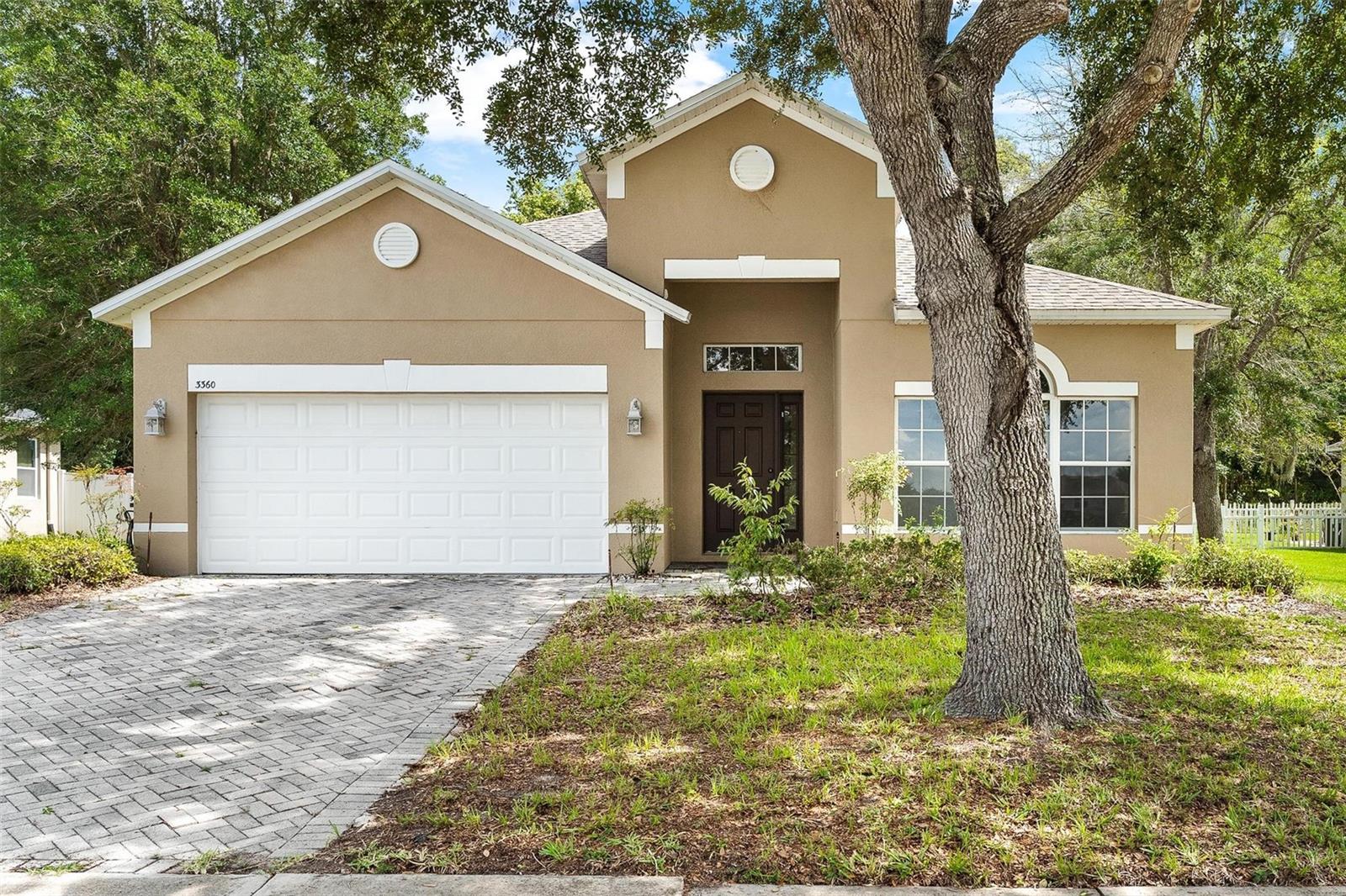 Welcome to this spacious 4-bedroom, 2-bath home tucked away on a quiet cul-de-sac in Spring Ridge Estates. Offering 1,952 square feet of living space, this home features a split-bedroom floor plan with two separate living areas, a formal dining room, and an eat-in kitchen complete with solid wood cabinetry, a breakfast bar, pantry, and brand-new stainless steel appliances. The primary suite includes a walk-in closet and a private bath with dual sinks, a garden tub, and separate shower. The additional bedrooms are located on the opposite side of the home, providing privacy and flexibility for family or guests. Step outside to the covered rear porch and enjoy peaceful conservation views with no rear neighbors. Additional features include luxury vinyl and tile flooring throughout, a paver driveway, fresh paint inside and outside, all new kitchen appliances, irrigation system, a 2022 roof and a 2-car garage. Located in the gated community of Spring Ridge Estates, residents enjoy access to community amenities including a park, fishing, and water access, all while being conveniently close to shopping, dining, schools, and the charming downtown areas of Eustis and Mount Dora.