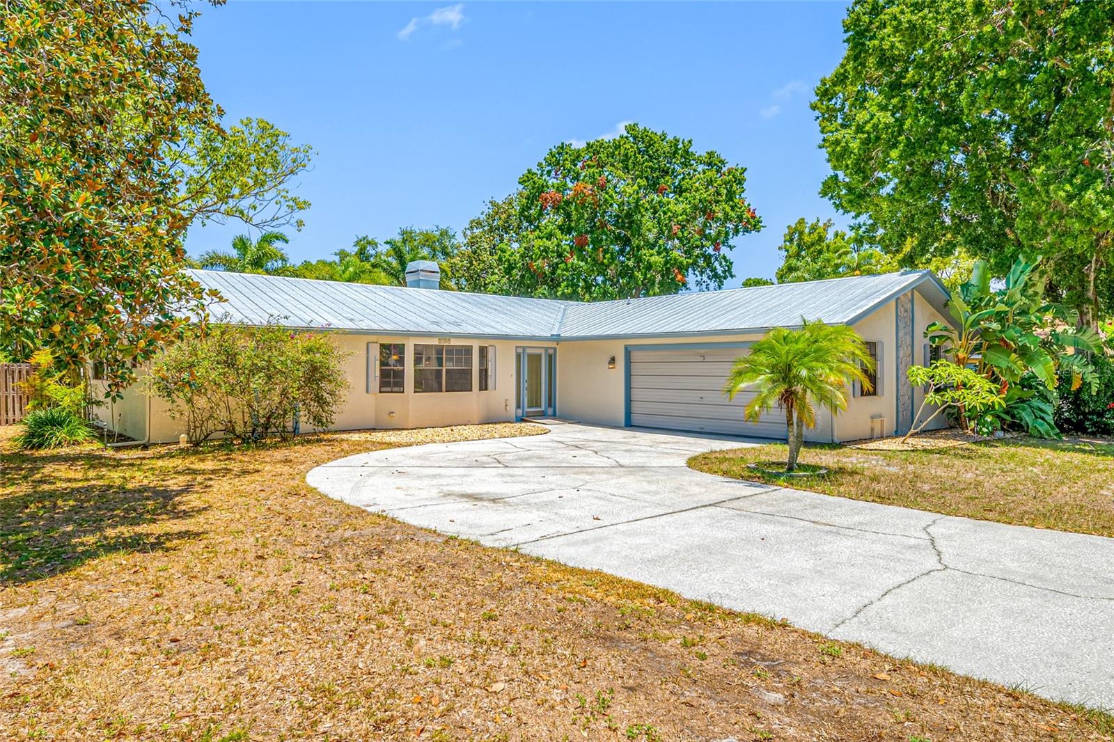 Welcome to Eagle Chase — a small, well loved Palm Harbor community with no HOA and no flood zone worries. 
This well maintained 3 bedroom, 2 bath, 2 car garage pool home sits on a quarter acre corner lot and offers 2,087 sq ft of comfortable, functional living.
Freshly painted interior in 2026, the home feels bright, clean, and move in ready. You’ll enjoy a spacious living and dining room combo, along with a warm and inviting family room featuring a wood burning fireplace. The large kitchen offers solid wood cabinetry, granite countertops, and generous prep space — ideal for everyday cooking or entertaining.
The split floor plan provides privacy, and the inside laundry room adds convenience. Flooring throughout is wood and tile — no carpet. The wood floors can be refinished to restore their original shine.
Step outside to your own Florida oasis: a screened pool and spa, a covered patio with a Thermador outdoor grill, and a fully fenced backyard with room to garden, including a raised garden bed ready for vegetables or herbs.
Major updates include a metal roof (2018), HVAC (2016), and water heater (2019) — offering peace of mind for years to come.
Golf enthusiasts will appreciate the proximity to Innisbrook Resort & Golf Club, home of the PGA Tour’s Valspar Championship. With easy access to US 19 and Belcher Road, commuting is simple, plus parks, shopping, dining, and entertainment are always close by.