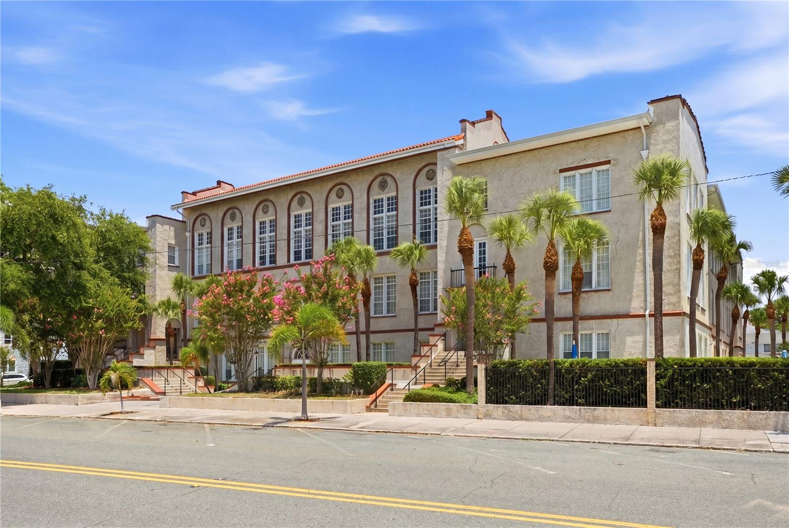 Virtually Staged. Rare opportunity to own a piece of St. Petersburg history. Once the former St. Petersburg High School, this iconic Mission Revival landmark was thoughtfully converted into residential condominiums in 1991. Overlooking beautiful Mirror Lake, the building remains one of downtown St. Petersburg’s most recognizable historic treasures, with "St. Petersburg High School" still engraved above the main entrance as a tribute to its storied past. This beautiful second floor condominium is located on the east side of the building and offers tranquil courtyard views and combines historic character with modern updates. The spacious two bedroom, two bath floor plan features high ceilings, large windows, and abundant natural light. Bamboo flooring flows throughout most of the living areas, while both bedrooms feature luxurious carpeting. The kitchen is designed for everyday living and entertaining with white shaker cabinetry, granite countertops, stainless steel appliances, and generous workspace. Recent improvements include a new refrigerator, new stackable washer and dryer, upgraded electrical service, new interior paint, new blinds throughout, and new ceiling fans in both bedrooms. An assigned parking space is included. Enjoy an exceptional downtown location just moments from Publix, waterfront parks, restaurants, cafés, breweries, shops, theaters, museums, hospitals, The Pier and the vibrant cultural attractions that make downtown St. Petersburg so desirable. Experience the perfect blend of historic charm, modern convenience, and urban living in one of the city’s most distinctive residential landmarks. Come see this remarkable condo today and make it yours tomorrow!