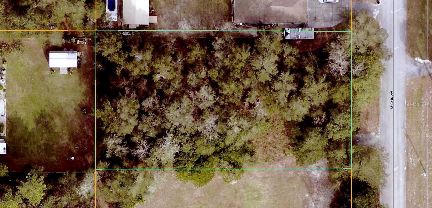 Nicely wooded lot with 102 ft of paved road frontage and No HOA! Located just off of HWY 42 in a great residential area that is close to The Villages for shopping, dining and entertainment. You choose the builder and when you want to build.