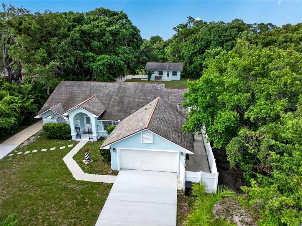 Exceptional Waterfront Residential/Commercial Opportunity in The Hammock!

Nestled in the heart of The Hammock along scenic A1A in Palm Coast, this rare 0.78-acre waterfront property offers an incredible blend of residential comfort and commercial potential. Featuring 100 feet of frontage on Fox Canal—with direct access to the Intracoastal Waterway in just minutes—and 100 feet of frontage on A1A, this prime location is truly one of a kind.

The property features a private gated entrance, oversized new paved driveway, a charming main residence, and a separate guest house. The main home offers 3 bedrooms, 2 baths, a spacious family room, dining room, kitchen, breakfast nook, and an expansive Florida room lined with French doors overlooking a peaceful, park-like backyard shaded by magnificent mature oak trees. Recent updates include a 2015 roof, 2022 water heater, and 2016 HVAC system.

The guest house includes a living room, kitchen with newer appliances, 2 bedrooms, 1 fully renovated bath, and a new stackable washer and dryer. HVAC was replaced in 2021.

Whether you're envisioning a private waterfront retreat, a home-based business, multi-generational living, or an income-producing investment with short-term rental potential, the possibilities are endless. Enjoy tranquil canal views, frequent visits from manatees and dolphins, and easy access to boating, beaches, dining, and shopping.

Conveniently located near Hammock Beach, Hammock Dunes, Yacht Harbor Village, Washington Oaks Gardens State Park, Jungle Hut Beach, Flagler Beach, and just 25 minutes from St. Augustine or Daytona Beach.

Location, Lifestyle, and Limitless Potential—this waterfront gem is ready for your vision. ???????