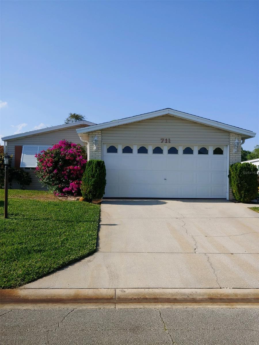 Enjoy living in Edgewater Landing, the 55 plus community on the Intercoastal Waterway where you own the land and have no lot rent.  This spacious 1994 Palm Harbor Triple wide  3 bedroom split plan home hosts an open floor plan with large living room and a family room that has a fireplace and built in bookcase,   formal dining room with built in china cabinet,  large eat-in kitchen with cork flooring and stainless appliances. Enjoy the private screened-in  lanai. Home has 2 stall garage and is located on a cul-de-sac. Home comes partially furnished and has custom window treatments.  Recent upgrades include:  New roof 2014, hot water heater 2017, Manufactured Hardwood floors through out 2017, Interior painting 2017, Daikin Air/Heat Conditioner Unit 2018 with transferable 12 year warranty, Lawn irrigation pump 2019, Hurricane Shutters 2020.   The landing has a clubhouse with  community heated pool, hot tub, tennis and pickleball courts, shuffleboard and bocce courts, walkway along the mile of frontage on the Intercoastal Waterway, wood-working shop, and exercise room. There is a lighted fishing dock and also a boat launch and dock with a seating area where you can sit back and watch the dolphins swim by.  There are storage areas for boats and RV's when space is available. ;Water: City