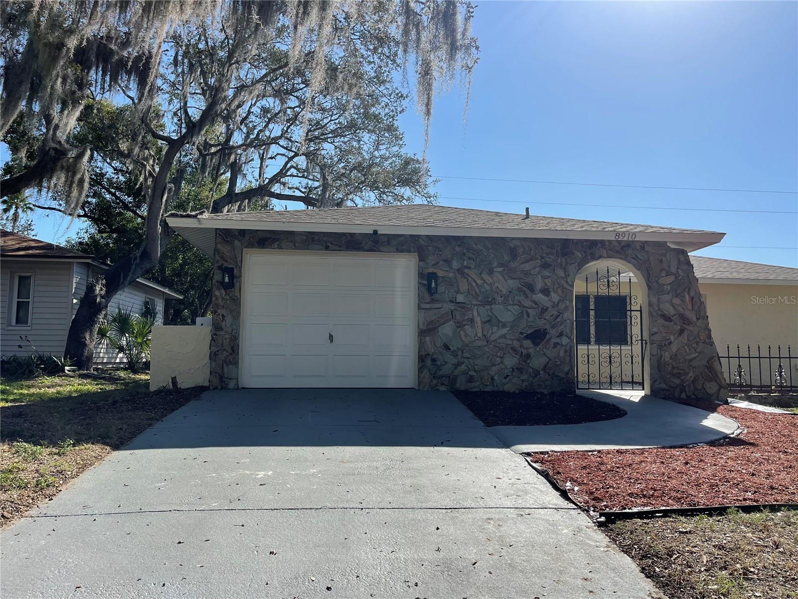 **Move-In Ready & Full of Charm!** Nestled beneath majestic oak trees in Forest Lake Estates, this inviting 2-bedroom home features an open-concept layout that seamlessly connects the living room, updated kitchen, and bonus room—perfect for everyday living and entertaining. Enjoy peace of mind with a **brand-new roof (May 2025)** and **new stainless steel appliance package** in the spacious, updated kitchen. Relax year-round on the screened back porch or unwind in the fenced backyard surrounded by beautiful shade trees. Conveniently located just minutes from **Lake Lisa Park, Gulf View Square, US-19, shopping, dining, and entertainment**, this home offers the perfect combination of comfort, convenience, and value. Don't miss your chance to rent this home!