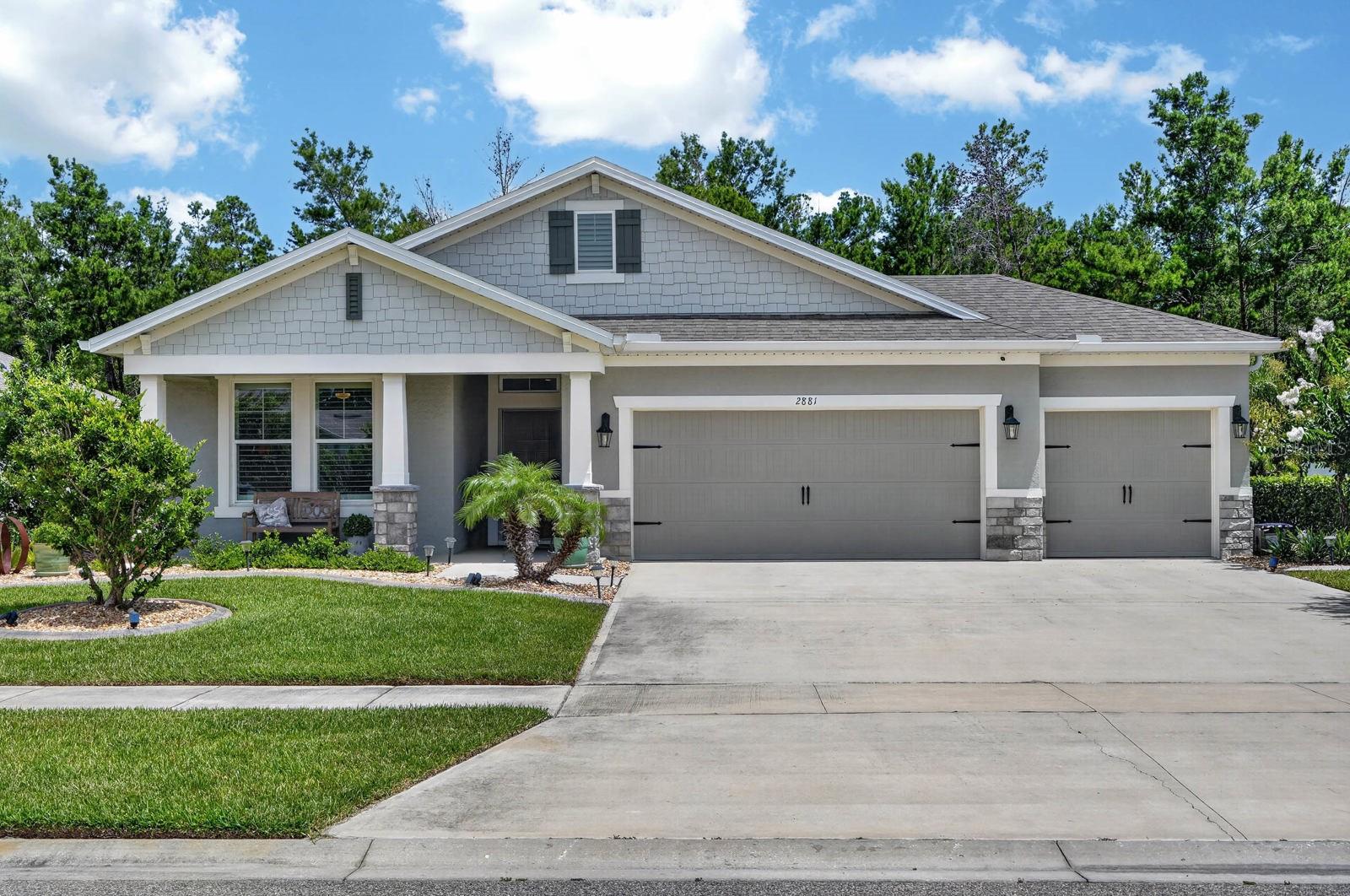 Welcome to Halifax Plantation, where thoughtful design meets everyday comfort. This beautifully updated 4-bedroom, 3-bath home offers over 2,100 square feet of well-planned living space with an open, split-bedroom layout that feels both spacious and private. Tall ceilings, oversized tile flooring, crown molding, and upgraded finishes create a clean, refined aesthetic throughout.

At the heart of the home, the kitchen flows seamlessly into the dining and living areas, making it equally suited for casual mornings or entertaining guests. The private primary suite is tucked away from the secondary bedrooms and features a generous walk-in closet and a spacious ensuite bath. Three additional bedrooms and two full baths provide flexibility for family, guests, or a home office. The oversized laundry room, walk-in pantry, and 3-car garage add everyday functionality.

One of the home's standout features is the expansive screened porch overlooking a peaceful natural preserve, creating an outdoor living space that feels private, quiet, and connected to nature. Whether you're enjoying your morning coffee, hosting dinner, or unwinding at the end of the day, this space truly extends the home's living area.

Built in 2022 and enhanced with smart home technology, custom plantation shutters, custom closet systems, upgraded lighting and fixtures, and professional landscaping, this home delivers the feel of new construction with the benefit of thoughtful owner-selected improvements. Located within Halifax Plantation, residents enjoy a low HOA and access to an established golf community just minutes from beaches, dining, parks, shopping, and I-95.