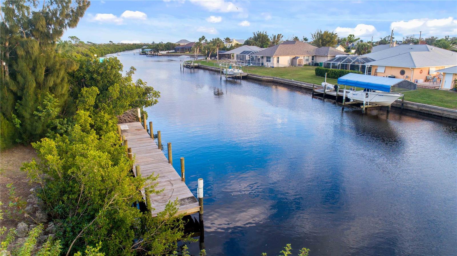 SAILBOAT WATER - NO BRIDGES to Charlotte Harbor / Gulf of Mexico. This oversized property is approximately 1/3 acre with 104' of waterfrontage. There are no deed restrictions, CDD fees or homeowners association. Electric, public water and public sewer are available. The 60'x8' wooden dock was newly added to the property in 2019. Located on the Countryman Waterway less than 500 yards from Charlotte Harbor. This location is a short drive to numerous shopping and dining areas, as well as beaches and boat ramps!