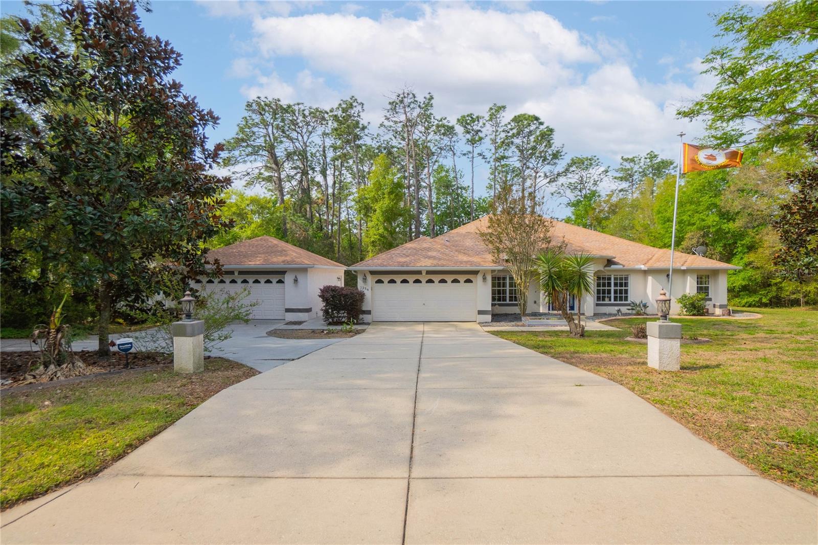 Welcome to your slice of paradise in the highly sought-after equestrian community of Pine Ridge! Situated on a beautiful 1-acre homesite, this well-appointed 4-bedroom, 2.5-bath home offers the perfect blend of space, functionality, and Florida lifestyle living. Step inside to a desirable split floor plan featuring an open-concept layout, vaulted ceilings, and abundant natural light. The formal dining room flows seamlessly into the spacious living area—ideal for entertaining—while the eat-in kitchen provides the perfect spot for everyday meals. Need a dedicated workspace? You’ll love the private office, offering flexibility for remote work, hobbies, or even an extra bedroom. The primary suite is a true retreat with generous space and a well-appointed bath, while the additional bedrooms are thoughtfully positioned for privacy and comfort. Outside is where this home truly shines—enjoy year-round outdoor living on your expansive covered lanai overlooking the screened-in pool, perfect for relaxing or hosting gatherings. Car enthusiasts, hobbyists, or those needing extra storage will appreciate not only the attached 2-car garage, but also the impressive 23x27 detached garage—a rare and valuable feature! Located in Pine Ridge, known for its equestrian-friendly lifestyle, miles of riding trails, and spacious homesites, this property offers both tranquility and convenience while still being close to shopping, dining, Suncoast Parkway, the Shoppes at Black Diamond, and the Gulf Coast.