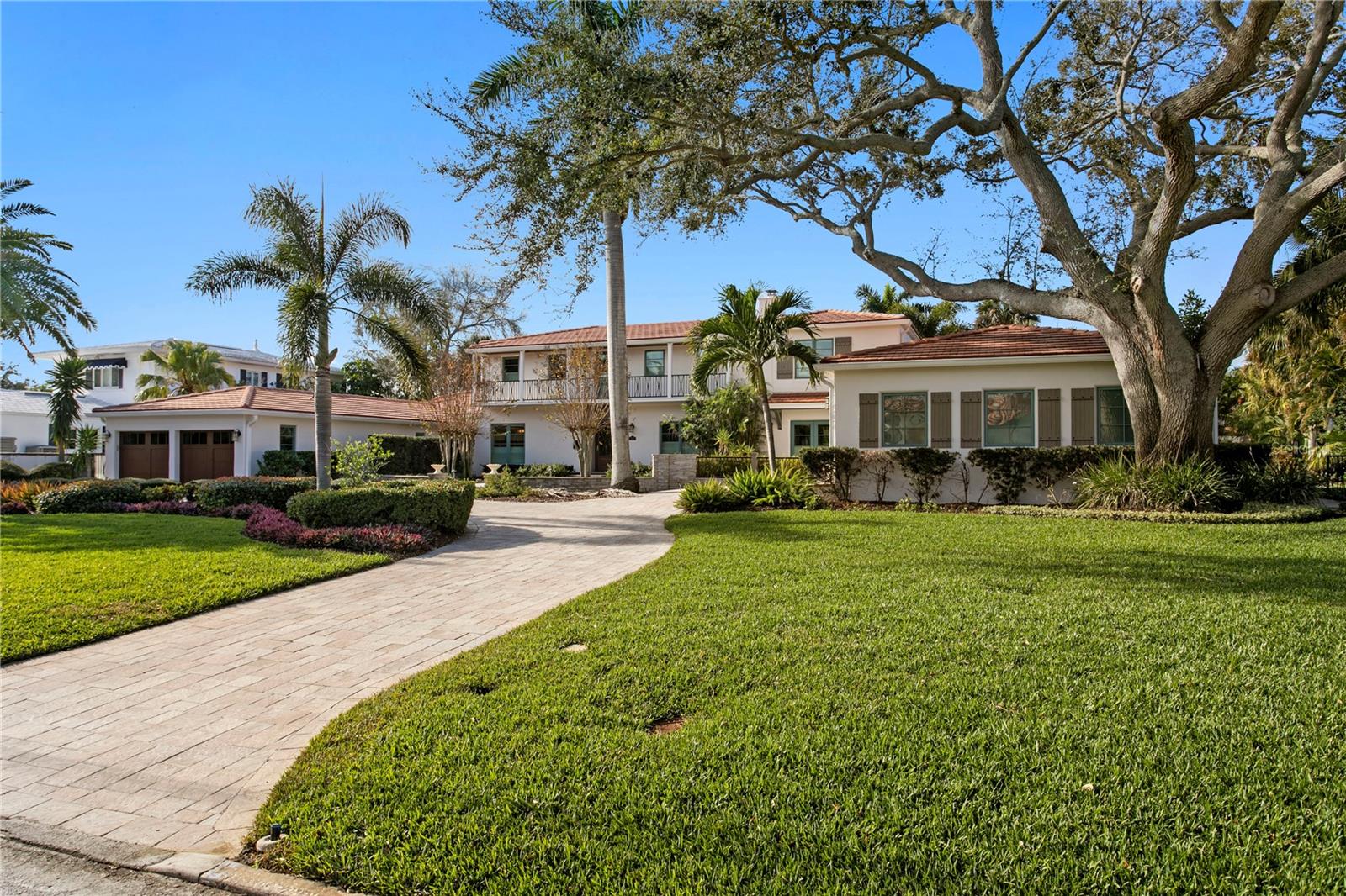 Situated on a rare DOUBLE lot (150x150' / over half an acre) on protected, deep-water in  Snell Isle, St Petersburg, this beautiful Santa Barbara style home with Art Deco flair, offers tremendous value. The lot has enough room to develop two new homes, offering buyers options: keep the house as-is, develop, or live in it and build at some later point- an excellent value, and on one of the areas most coveted streets! 
An elegant, exceptionally well-built example of timeless classic meets contemporary living, architecturally the home and property is beautifully proportioned, with great curb appeal,   approx 5,733 htd. sqft, with an amazing home theater, a wine room,  two primary suites (one upstairs, one downstairs), and a gourmet kitchen with huge Island, top-of-the-line appliances, separate breakfast nook and cocktail area and french doors that open out to the waterfront. Custom finishes throughout highlight the beautiful details.  Art Deco foyer, gorgeous stairwell, beautiful bathrooms (including an outdoor one). and light filled rooms with newly replaced Pella windows and doors throughout over the past few years.. Interior spaces are upscale yet comfortable and luxurious, with large rooms that flow together. The kitchen opens to the dining room, living room, and family room. The living room with fireplace features hidden pocket doors to the downstairs theater and bedrooms for privacy. The upstairs primary suite offers resort style luxury with its beautiful spa-like bathroom suite, large walk-in closet and sitting area overlooking the waterfront. The fifth bedroom is currently an elegantly outfitted  executive office with French doors opening out to the waterfront. All the upstairs bedrooms have waterfront views, and the downstairs bedrooms have french doors that open out to  putting green, pool and waterfront areas . Exterior amenities are an entertainer's dream: patios ,wonderful large pool area with spa, golf/putting area, covered patio/outdoor room with electric fireplace  and grill, and large dock with 20,000-pound boat lift - all create the perfect setting for waterfront living. Dual garages – a two-car and a one-car (perfect for golf carts, water toys, or another car), large front garden with a wide circular drive . An easy walk to downtown St Pete, and a very short ride to all that  downtown St Petersburg has to offer – from the Pier to the Vinoy Hotel, (the Vinoy golf course and Clubhouse is a shot walk or golf cart ride from the home),  the marinas, restaurants, theatres, museums and galleries, boutiques & coffee spots. A world of entertainment, right at your fingertips,  World renowned beaches and the Tampa International Airport is with 30 mins .