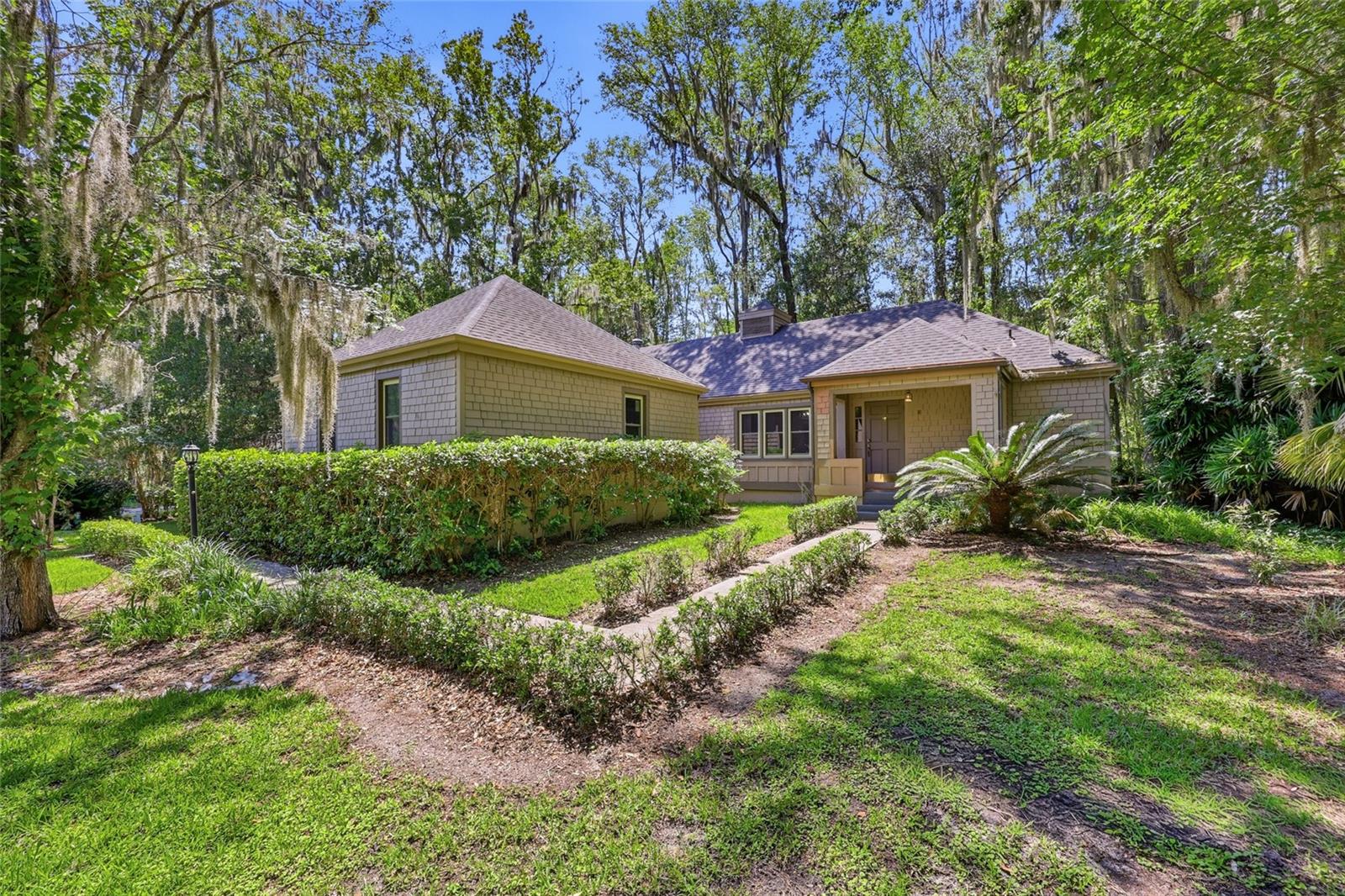 Virtually Staged. Come enjoy the charm and convenience of Haile Plantation in this inviting 1600sqft, 4-bed, 2-bath home tucked away on more than a quarter of an acre on a quiet cul-de-sac in Laurel Park. Thoughtfully maintained, this home offers comfortable living spaces, a welcoming layout, and the peaceful setting Haile is known for. This home is truly move-in ready with many updates throughout - new windows, new HVAC, new water heater, updated electric and PVC plumbing, and newer washer and dryer. Inside, you’re greeted by an open floor plan with high ceilings and a cozy wood-burning fireplace that anchors the living area. The layout flows easily into the dining space and kitchen, making everyday living and entertaining feel effortless. You’ll appreciate updated luxury vinyl plank flooring throughout the home, no carpet! Beyond the kitchen is a flexible space perfect for an office, a breakfast nook, or a large mudroom. The home features a split bedroom plan with the spacious primary suite on one side and three additional bedrooms on the other. The primary bedroom includes a large closet, a door to the backyard, and an ensuite bathroom with quartz counters and a tiled walk-in shower. Three additional bedrooms offer space for the whole family as well as guests. They have easy access to the hall bathroom which features convenient custom built-in storage, a vanity with quartz counters, and a tub-shower combo. Step outside the French doors in the living room to your private backyard centered around a generously sized gazebo—perfect for relaxing, hosting gatherings, or enjoying the shade on warm afternoons. The two car garage offers ample room for cars, tools, or a workshop. Pull-down attic stairs lead to a sizable walk-in attic space, providing excellent storage. Mature tangerine trees add a touch of Florida charm to the property. Located in Haile Plantation’s Laurel Park, this home offers easy access to Haile Village Center, the Saturday Farmers Market, local schools, restaurants, and shopping. Enjoy miles of walking trails, nearby horse farms, and optional membership amenities including golf, pool, fitness center, and tennis. With quick access to I-75 and Shands/UF, the location blends convenience with a community-focused lifestyle.