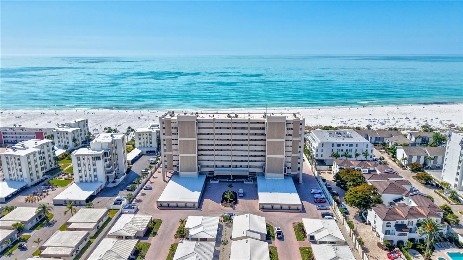 Experience the ultimate Siesta Key beach get-away in your TURNKEY FURNISHED, west-facing condo at Horizons West and just steps from your private beach with plenty of beach chairs and five sun cabanas.  Enjoy the crystal sands of Crescent Beach where the sand is always cool and you’ll never miss a sunset. This spacious 1-bedroom retreat boasts over 1,000 sq. ft. and has tiered ceilings up to 9 ½ feet. The west facing wall of oversized 6-foot-high impact windows frame breathtaking panoramic Gulf, beach, resort pool and sunsets sunset views, including dolphin sightings. Perched above the lobby and mezzanine, use the elevator to enter this bright and cheerful end-unit with west and south facing windows in the living room. Enjoy an open, airy floor plan with a designer kitchen featuring stone countertops, stainless appliances, and a breakfast bar. The generously sized bedroom has south and east facing windows and an en-suite bathroom with a beautifully tiled walk-in shower. Resort-style amenities abound: 300 ft. of private beach, two pools, spa, cabanas, grills, and a bayside park with day dock. This unit comes with private carport storage for all your beach toys. Hop on the free Siesta Key trolley for world-class dining and shopping. Come see why Siesta Key is ranked the #1 Beach in the USA and #4 in the world—your piece of paradise awaits!