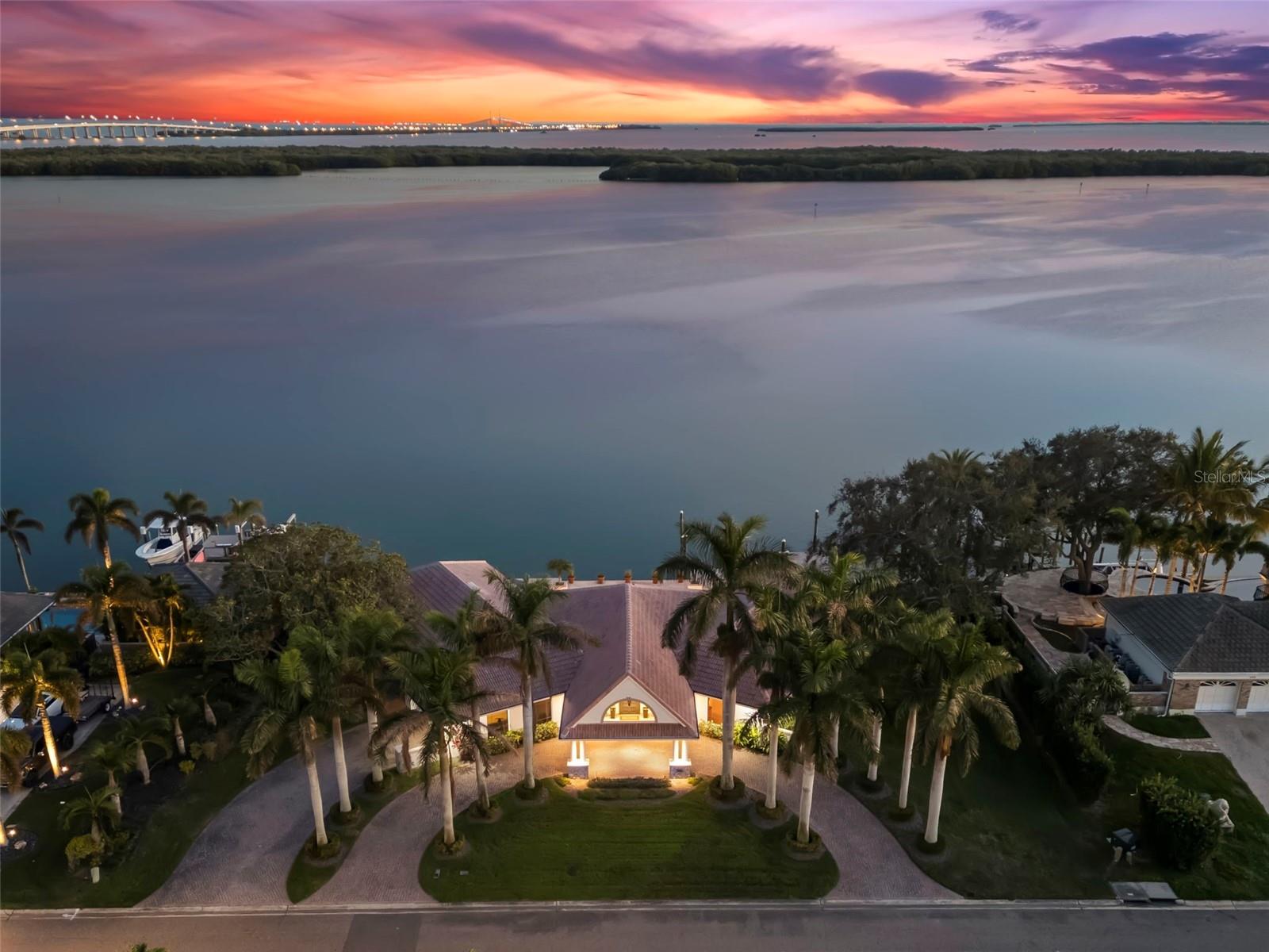 **PRICED UNDER RECENTLY APPRAISED VALUE** **SELLER OFFERING AN ADDITIONAL $20,000 BUYER CREDIT** 

Experience LUXURY in this 3 BEDROOM, 4 BATH 3,822 sq. ft POOL HOME in the EXCLUSIVE BAYWAY ISLES. This homes features 156 FEET OF WATER FRONTAGE, PRIVATE DOCK with DEEP WATER GULF ACCESS, with gorgeous UNOBSTRUCTED WATER VIEWS. This estate is situated on a large, NEARLY 1/2 ACRE OVERSIZED LOT, in a secure, 24-HOUR GUARD GATED , ISLAND COMMUNITY. This well maintained home seamlessly blends mid-century modern interiors with timeless charm. It boasts breathtaking views & direct access to the beautiful waterways of Tampa Bay. This home is nestled on a rare oversized 1 and 3/4 lot. It offers unparalleled open water views of Tampa Bay.  As you arrive to this property, you will begin to notice each carefully crafted detail. The circular drive way is lined with mature Royal Palm trees. You will be greeted under the custom porte-cochère covered entryway. Upon crossing the front door threshold, you'll be welcomed by the grandeur of this home's rotunda foyer. The eye-catching CUSTOM TERRAZZO FLOORING seamlessly complements the exquisite oak hardwood flooring that graces the rest of this estate. The home is filled with natural light making it an amazing space for the Art Collector. Enjoy true indoor/outdoor living with an OPEN FLOOR PLAN, that seamlessly connects your living spaces to the stunning outdoors & unobstructed views of Tampa Bay. The kitchen is beautifully appointed with Subzero Refrigerator, European appliances, and a temperature controlled WINE CELLAR. There is CUSTOM CABINETRY throughout this residence as well as a central vacuum. It boasts cedar-lined closets in the Primary and Secondary bedroom and  electric HURRICANE SHUTTERS on all rear exterior windows. Unwind by the pool with a picturesque water vista. Jump into your boat from the private dock with deep-water access for a short ride to the Gulf of Mexico. Florida living doesn’t get much better than this! Secure your private showing today to indulge in the pinnacle of LUXURY living!