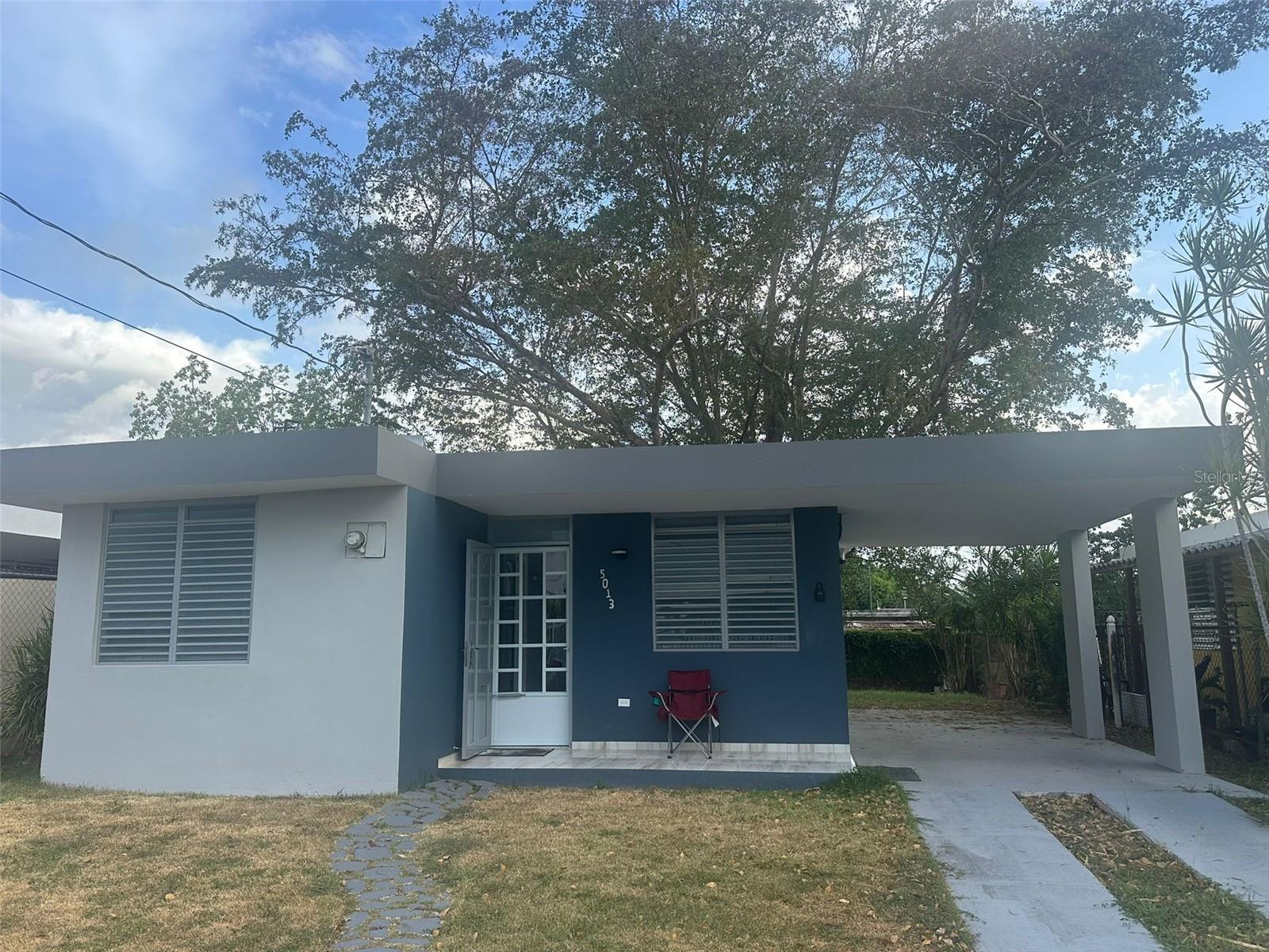 Cozy 2-bedroom, 1-bathroom residence featuring a living room, dining room, kitchen, carport, and backyard. Located at Extensión Elizabeth Subdivision, F-14, 5013 Colosense Street, Cabo Rojo, Puerto Rico.