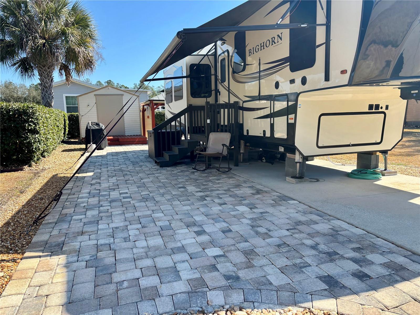 Spacious Vacant RV Lot in The Town Park at Wilderness RV Park – 55+ Community – Loaded with Extras! Discover your perfect Florida retreat in the highly desirable Town Park at Wilderness RV Park, a vibrant 55+ community that blends tranquility with convenience. This beautifully maintained vacant RV lot is ready for your RV and outdoor living dreams. Property Highlights: Spacious RV-ready lot, Pergola with paver patio – perfect for relaxing or entertaining outdoors, Storage shed included – ideal for storing tools, outdoor gear, or seasonal items, beautiful landscaping and well-kept surroundings. Enjoy the Florida lifestyle year-round with access to community amenities like private clubhouse with heated swimming pool, hot tub, fitness center, shuffleboard courts, nature trails, and social events. Whether you're a seasonal snowbird or a full-time resident, this lot offers comfort, convenience, and a sense of community. Don't miss this opportunity to own a slice of paradise in one of Florida’s premier 55+ RV communities! Direct access to the Ocklawaha River and Florida Greenway Trails for kayaking, fishing, hiking, and biking. The HOA fee covers sewer, water, trash, private roads, grounds maintenance, and full access to all community amenities—making life easy and worry-free. Located just minutes from Silver Springs State Park, shopping, dining, and historic downtown Ocala, with East Coast beaches just an hour away, this is the perfect place to enjoy the best of Florida living. Your dream lot is waiting—schedule your showing today! Please NOTE: you own the land and the lot is deeded in your name.