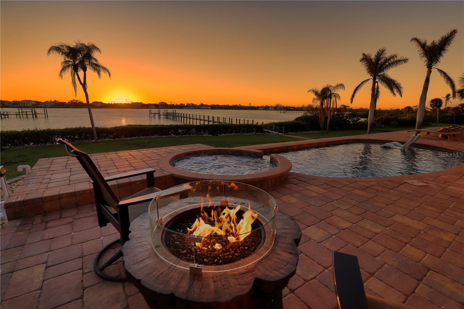 A rare opportunity to own one of Lemon Bay’s most exceptional private waterfront estates. Set on more than an acre along the bay’s widest expanse, this fully reimagined coastal retreat delivers extraordinary privacy, breathtaking sunsets, and resort-style living in the heart of Englewood.
Completed after an extensive two-year renovation, the elevated main residence blends timeless architecture with impeccable finishes and modern resilience. The 2-bedroom, 2.5-bath home features expansive water views, open-concept living spaces, and a stunning chef’s kitchen appointed with custom rift-sawn white oak cabinetry, Cambria surfaces, Wolf and Sub-Zero appliances, dual dishwashers, and a generous Galley workstation sink. A dramatic wall of sliding glass opens to an extraordinary outdoor setting with a saltwater pool and spa, covered summer kitchen, fire features, and multiple spaces designed for entertaining or quiet relaxation.
The completely remodeled 3- bedroom, 2 bath private guest house creates an ideal compound for family, extended stays, or distinguished visitors, offering seasonal sunset views, 2 full kitchens and laundry and living areas with their own saltwater pool and infinity spa.
Built for comfort and peace of mind, the estate includes hurricane-impact glass, new electric and plumbing, 13ft elevation, whole house generators for both main house and guest house, metal roofing and spray foam insulation, and premium construction enhancements - too many to mention here. This property is as storm proof as it is charming and elegant.  Must be seen to be fully appreciated. Please note: Recent improvements include a newly added panoramic-screen lanai enclosure designed to enhance the property’s exceptional water views and outdoor living experience.