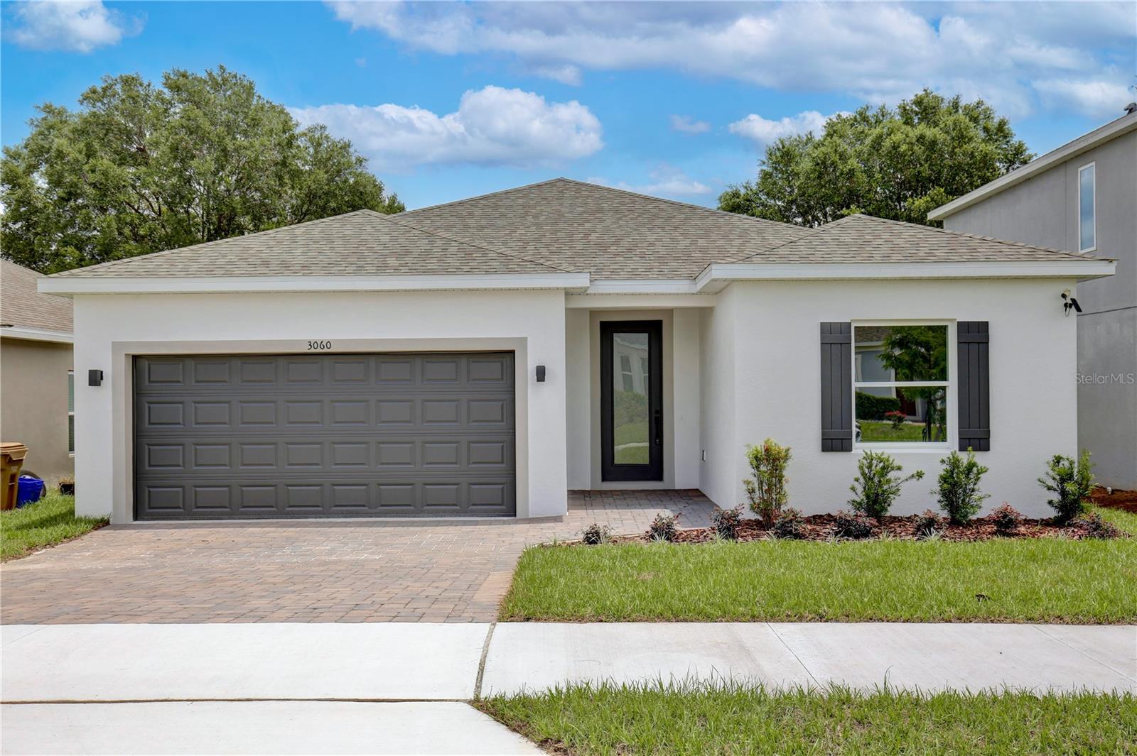 New Construction. Move-In Ready! Single Level 5 bedroom / 3 Bathroom home with no rear neighbors, and breathtaking conservation views. TAKE ADVANTAGE OF UP TO $20,000.00 IN FLEX FUNDS, NO CDD FEES, and affordable HOA! With 2,200 living sq. ft. and 5 bedrooms / 3 full baths, this beautifully crafted home is perfect for versatile living. Enjoy elevated 9’4” ceilings throughout, a gourmet kitchen with quartz countertops and premium cabinetry, a luxurious primary suite with a spacious walk-in closet and shower glass enclosure. Additional highlights include stylish porcelain tile flooring, a two-car garage with an automatic opener, and a charming brick paver driveway, along with covered front and rear patios perfect for outdoor relaxation. Enjoy proximity to the Florida Turnpike, major shopping centers, and diverse dining options. Make this stunning new construction home in Groveland yours today!