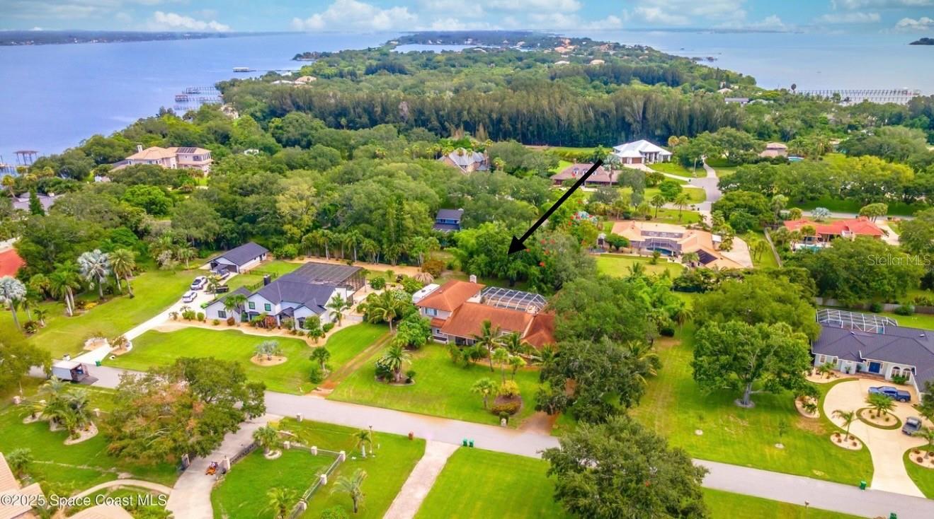 You won't find a better DEAL in BREVARD County!! Discover one of the county's most unique communities with 1-acre lots and a private 21-slip marina! Nestled between the Banana and Indian Rivers on scenic S. Tropical Trail, this 5,000+ SF home is a boater's paradise, a mechanic's dream, and a movie lover's retreat. It offers 4 beds, 4 baths, an office, a theater room, and a 4-car garage. Enjoy true island living on 1 acre with an RV pad and an 8k-lb lift in your dedicated marina slip. The fully fenced yard is framed by oaks, coconut palms, and lush tropical landscaping. A screened, heated saltwater pool with hot tub and bar creates the perfect entertaining space. Inside, a split floor plan provides privacy, enhanced by high coffered ceilings and three fireplaces. The gourmet kitchen is ideal for chefs, while the 900-sf owner's retreat boasts a private balcony and spa-style bath. Home warranty included! Metal roof (2015), solar attic fans (2025), and newer AC (2024). **Assumable VA loan 2.85%**