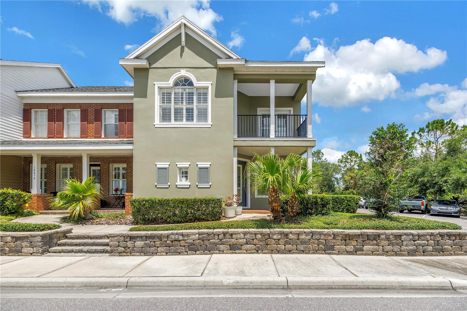 Welcome to 14652 Bournemouth Road. This builder's model home is a beautifully maintained lakefront end-unit townhome in Tampa’s desirable Highland Park community. Set along scenic Galt Lake, this home offers the kind of peaceful water views and natural light that make everyday living feel a little more relaxed.

Inside, the home is warm, comfortable, and thoughtfully upgraded, with an open main living area that connects the kitchen, dining, and living spaces with ease. Tile and engineered hardwood floors, crown molding, plantation shutters, custom lighting, and designer details add character throughout, while the kitchen features granite countertops, a gas stove, stainless steel appliances, upgraded cabinetry, a tile backsplash, and a generous workspace for cooking or entertaining.

The first-floor primary suite is a standout feature, offering convenience, privacy, and a calm retreat at the end of the day. Details such as a tray ceiling, crown molding, custom closet system, dual sinks, and a separate garden tub create a space that feels both practical and inviting.

Upstairs, two secondary bedrooms provide plenty of room for family members, guests, work-from-home needs, or flexible living. A spacious loft or bonus room with French doors opens to a private balcony overlooking the lake, creating one of the home’s most memorable spaces. It is the perfect spot for morning coffee, an evening drink, or simply watching the birds and wildlife along the water.

Outdoor living is another major highlight. Between the welcoming front porch, screened and covered lanai, fenced backyard, and upstairs balcony, there are multiple places to relax and enjoy the setting. The fenced courtyard nestled between the lanai and 2-car garage offers the feel of a single-family home, while the townhome lifestyle keeps maintenance more manageable.

Highland Park is known for its charming neighborhood feel and impressive amenities, including a resort-style pool, fitness center, clubhouse/lake house, parks, playgrounds, walking paths, and community gathering spaces. With close proximity to Westchase, shopping, dining, Tampa International Airport, and Gulf Coast beaches, this home offers a rare combination of lakefront living, everyday convenience, and low-maintenance comfort in one of Northwest Tampa’s most appealing communities.
