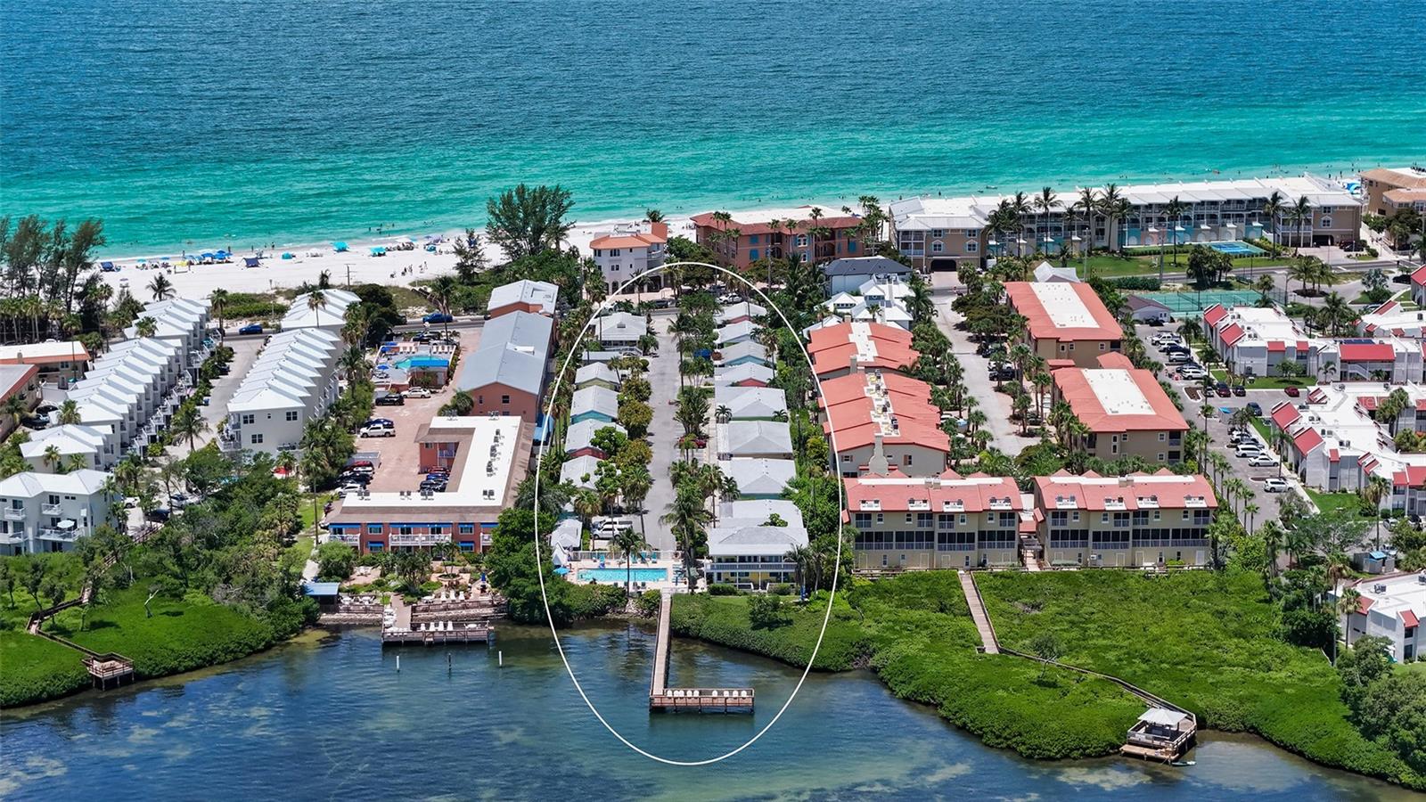 Experience the charm of Old Florida living just steps from the Gulf of Mexico at this beautifully renovated turnkey-furnished beach cottage in the sought-after Tradewinds Beach Resort on Anna Maria Island. Whether you're searching for a carefree island retreat, an income-producing vacation rental, or the perfect blend of both, this stylish one-bedroom residence offers exceptional flexibility with no minimum rental restrictions and professional on-site management available.
Completely remodeled with a fresh coastal aesthetic, the interior is move-in ready, and designed for immediate enjoyment. Soft tropical hues, wood-look tile flooring, and an open floor plan create a bright, inviting atmosphere, while the updated kitchen showcases stone countertops, custom cabinetry, newer stainless steel appliances, and generous workspace. The beautifully renovated bath echoes the same timeless finishes, and in-residence washer/dryer provides added convenience. Offered turnkey furnished, the residence includes a king-size bed, queen sleeper sofa, two flat-screen televisions, and tasteful décor, allowing you to begin enjoying island life from day one.
Outside, a shaded private front patio with a newly installed paver walkway provides the perfect setting for morning coffee or evening cocktails, while assigned parking is conveniently located just outside your door. Offering added peace of mind, the home has been thoughtfully updated with Hardie® siding, impact-rated windows and doors, and new plumbing and sewer lines.
Tradewinds Beach Resort captures the relaxed character that has made Anna Maria Island one of Florida's most beloved destinations. Pastel-colored cottages draped in jasmine and bougainvillea line a quiet private lane leading to a heated bayside swimming pool, fishing pier, picnic pavilions, charcoal grills, and beautifully landscaped grounds. Across the street, deeded beach access leads to the powdery white sands and turquoise waters of the Gulf of Mexico, where unforgettable sunsets become part of everyday life. The pet-friendly community also offers on-site laundry facilities and optional rental management services, including housekeeping, beach loungers, umbrellas, and guest services, making ownership effortless.
Perfectly positioned just moments from Historic Bridge Street, you'll enjoy easy access to waterfront restaurants, local boutiques, live entertainment, fishing charters, and island cafés. The free Anna Maria Island Trolley stops nearby, providing convenient transportation to Holmes Beach, Anna Maria, Coquina Beach, and additional island attractions. Whether you're spending your days boating, paddleboarding, shelling along the shoreline, or exploring the island's vibrant dining scene, this exceptional residence offers the quintessential Anna Maria Island lifestyle with outstanding rental potential.