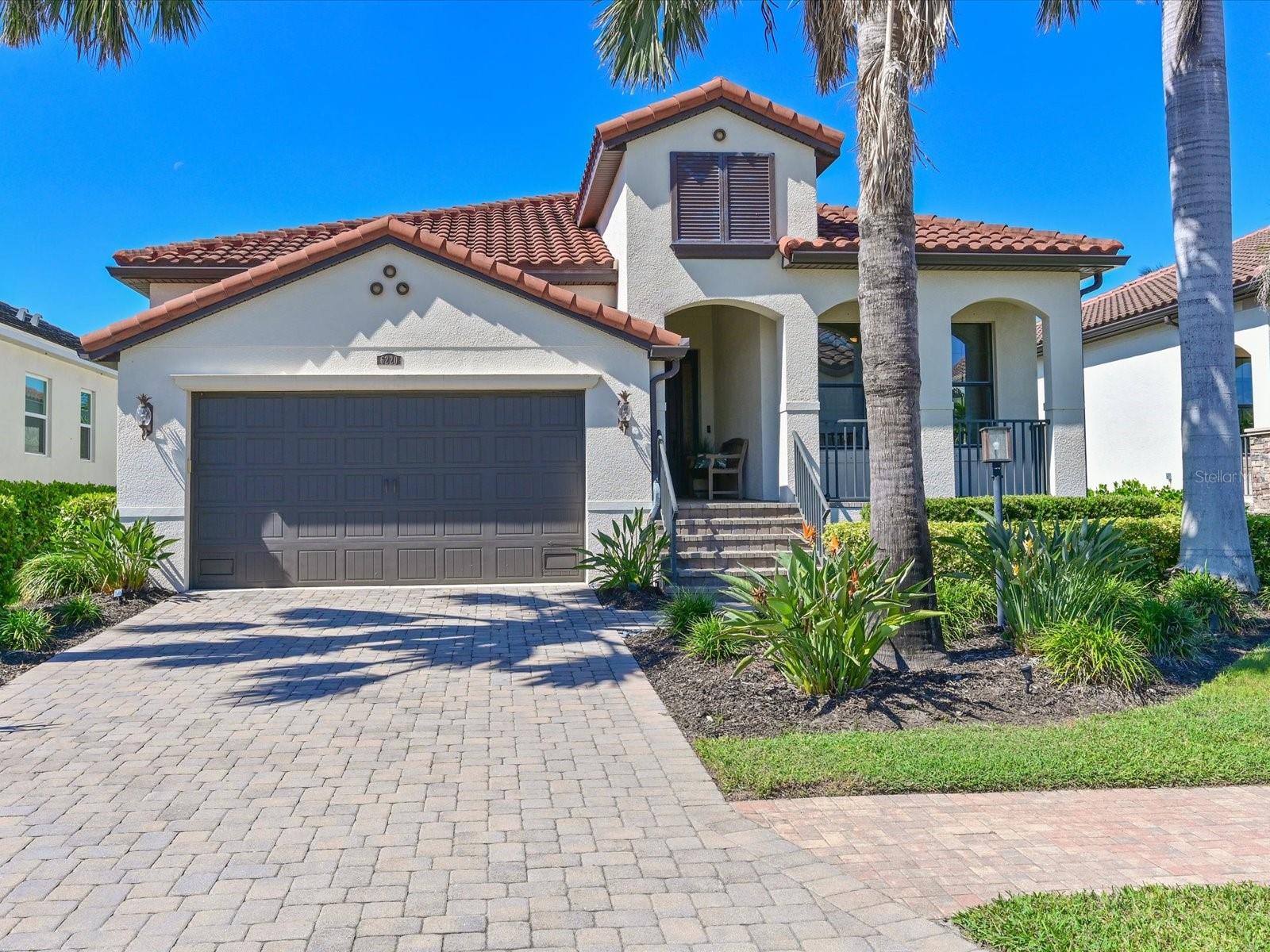 FOUR BEDROOM AND 2 1/2 BATH HOME IN THE HIGHLY DESIRABLE GATED COMMUNITY OF LEGENDS BAY! Original owner has meticulously maintained this home. This home has over $100,000 in decorator touches and upgrades. Enter into the spacious foyer with custom light fixtures, tray ceiling with crown molding and designer wall finishes. 18" ceramic tile flooring guides you into the spacious gathering area consisting of the great room, living room and kitchen.  The gourmet kitchen has everything an aspiring chef could need.  Stainless steel appliances include a three-door refrigerator/freezer with dual ice output, built-in microwave and oven, 5 burner gas stove and new LG dishwasher.  Wood cabinetry offers plenty of storage with easy to use pull out drawers and soft close features. The large corner pantry has solid wood slat shelving. Diana Reale marble countertops and travertine backsplash adorn this area.  The kitchen island offers casual seating for up to four. The dining area is optimal for more formal meals; two large windows offer light and views to the outdoor area. The spacious great room is perfect for larger gatherings or just relaxing watching TV.
Enter the primary bedroom with ensuite bath consisting of large vanity with dual sinks, soaking tub and huge walk-in shower.  A separate toilet room and walk-in closet complete this private area in the rear of the home.
This split floorplan has two guestrooms and full bath with tub/shower combo on one side of home, making these perfect for family or guests.
The fourth bedroom is currently used as an office and has engineered hardwood floors. A separate half bath is conveniently located for guest use. 
Save the best for last:  Walk out to your private custom designed lanai and pool area.   The covered lanai with travertine tile flooring boasts a large seating space to relax and unwind with friends and family.  A custom outdoor kitchen has marine grade polymer cabinetry with drawers and pull-out shelves to store everything you need to create an outdoor meal.  A Hestan commercial grade stainless steel grill with built-in rotisserie and infra-red burner can cook just about anything you desire including pizzas.  The kitchen also includes 2 gas side burners, an outdoor beverage refrigerator and granite countertop and backsplash.
Relax and unwind in the custom designed concrete (not Gunite) pool with waterfall fountain and a sun shelf for relaxing and viewing sunsets or native Florida birds in the small creek behind the home. 
Florida friendly landscaping surrounds all sides of the home and is watered with recycled water for irrigation provided in the HOA fee. Automated 12volt landscape lighting highlights the home and palms in the evening.
Legends Bay is a gated community located along Sarasota Bay. Enjoy local activities in Bradenton and Sarasota.  Legends Bay is located just ten minutes from Sarasota International Airport and 55 minutes to Tampa International Airport.  World renown IMG Academy campus is 3 miles nearby and IMG Golf Course is a golf cart ride away. Explore Downtown Bradenton with its historic charm and the Manatee riverfront or venture south to Downtown Sarasota with fine dining, exciting venues such as the Van Wezel Performing Center and Sarasota Opera House and the well-loved St. Armand's Circle. Check out local activities and markets along the crystal sand beaches of Bradenton Beach and Anna Maria Island.   Every day holds an adventure within minutes of your new home!