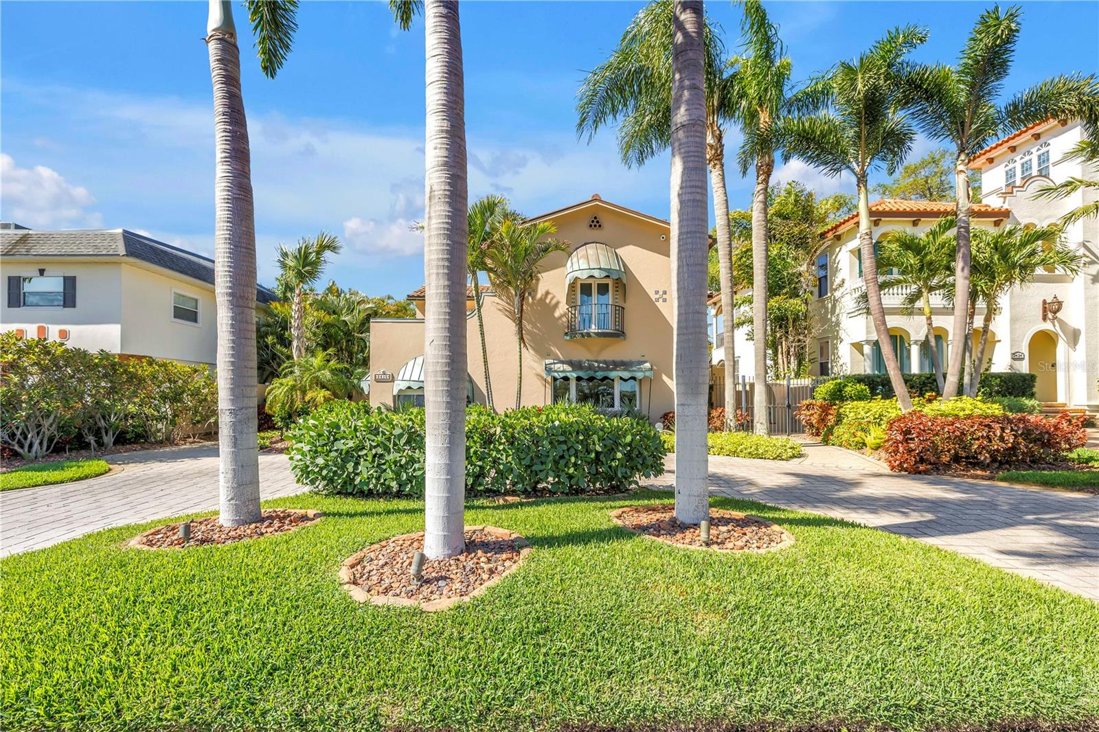 One or more photo(s) has been virtually staged. Set along the iconic curve of Coffee Pot Boulevard, and Coffee Pot Bayou, is this extraordinary 1925 Mediterranean-style residence offers a rare fusion of historic grandeur and modern coastal luxury. This 3,469 square foot home, listed on the Historic Register, has been meticulously restored. State-of-the-art appliances and modern technologies create the ultimate experience in comfort and luxury living. The property commands sweeping views of Coffee Pot Bayou from nearly every vantage point. 
Classic Spanish Revival architecture defines the residence, with graceful Roman arches, refined millwork, and thoughtfully preserved details that honor its heritage. Three expansive bedrooms and four-and-a-half beautifully appointed baths provide both convenience and privacy. Interior upgrades include wide-plank wood floors, elegant crown molding.  The compound boasts three gas fireplaces—two indoors and a dramatic outdoor centerpiece that anchors the home’s alfresco living spaces.
At the heart of the home, a custom-designed kitchen pairs timeless style with modern performance, featuring premium Thermador appliances, granite countertops, and bespoke finishes ideal for both intimate gatherings and refined entertainment.
Outdoor living is nothing short of exceptional. A private water lot located directly across the street includes a newly constructed dock and a 14,000-pound boat lift, offering effortless access to the bayou. A newly added second-floor patio provides a shaded retreat with tranquil water views, while the redesigned pool and entertainment area showcases a Pentair pool system, a high-end outdoor kitchen, a 98-inch Seura outdoor television, and a remote-controlled sunscreen—creating an idyllic setting for year-round coastal living.
The estate rests on a solid concrete foundation and has been extensively enhanced with renewed flooring throughout, waterproofed first-floor walls, copper downspouts, custom awnings and window treatments, and a striking handcrafted front door. Impact-resistant windows and doors ensure both beauty and resilience. Additional features include a solar-powered rear gate, renovated two-car garage, dual sump pumps, an advanced Aniks insect prevention system, and a modern tankless water heater.
Following water impact from Hurricane Helene, the entire first level and all flooring were comprehensively renovated, resulting in a cohesive, refreshed interior that seamlessly blends old-world charm with contemporary refinement.
Moments from downtown St. Petersburg’s vibrant arts scene, waterfront parks, and acclaimed dining, this distinguished residence stands as a timeless expression of Mediterranean elegance—offering an unparalleled lifestyle in one of the city’s most coveted waterfront enclaves.