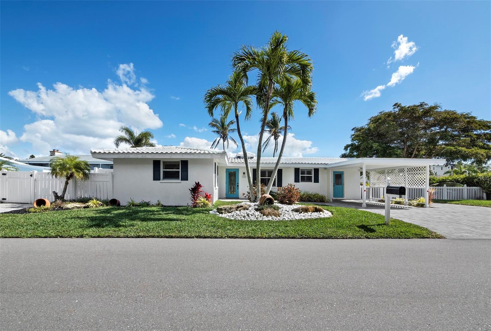 Coastal Living Perfected on Longboat Key Discover the ultimate island retreat at 726 Jungle Queen Way, a beautifully reimagined 2-bedroom, 2-bath waterfront home where modern comfort meets timeless Florida charm. Tucked away on a peaceful canal just steps from the Gulf of Mexico, this residence offers the rare privilege of deeded beach access, 125ft canal frontage, and a resort-style saltwater pool - everything you need to live each day like a vacation. Wake up to soft morning light glistening off the water and ease into your day with coffee poolside, surrounded by lush tropical landscaping and the hush of palm fronds swaying in the breeze. Launch your boat from the private dock pilings on the deep-water canal and explore Sarasota Bay or head out toward Egmont Key. After a day on the water, rinse off in the outdoor shower, slip into the saltwater pool, or unwind on the travertine deck beneath wide island skies that glow at sunset. Evenings invite laid-back luxury - cocktails by the firepit, good company, and a canopy of stars overhead. Inside, this home blends classic coastal character with thoughtful, high-end updates throughout. The light-filled living spaces feel open yet intimate, with plantation shutters, fresh neutral tones, new baseboards and trim that anchors the living room with style. The redesigned kitchen shines with quartz countertops, stainless-steel appliances, and sleek cabinetry, while both bathrooms echo a spa-inspired sensibility with crisp, elegant finishes. The family room’s canal views beyond the French doors provide a quiet reminder that you’re always connected to the water. Recent updates lend peace of mind with new HVAC (2019), refreshed interior paint, new interior doors, and professional flood mitigation - including new drywall and rewired electrical. The exterior is equally turnkey, with manicured landscaping, a paver driveway, and a shaded carport for convenience. Living on Longboat Key means embracing an effortless, elegant coastal lifestyle. From here, you’re minutes to St. Armands Circle, Anna Maria Island, and downtown Sarasota, with boutique shopping, fine dining, dog-friendly parks, and beach paths all within easy reach. Boat in the morning. Beach at sunset. Poolside under the stars. This is more than a home - it’s the Longboat Key lifestyle realized.
