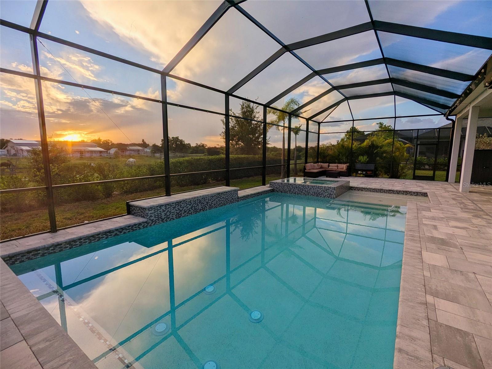 NO CDD | ALL NEW POOL/SPA PACKAGE | 3 CAR GARAGE | PASTORAL VIEW | 75' WIDE LOT | 12' CEILINGS. Welcome to your recently built 4-bedroom, 3-bath residence in gated Worthington with a dedicated den, oversized 3-car garage, and floor plan designed around Sarasota’s indoor/outdoor lifestyle. Outside, the private resort-style setting features an all-new pool, elevated infinity edge spa, splash pad, generous covered seating area, and expansive caged patio, all against an open equestrian backdrop. Inside, 12-foot ceilings, transom windows, and an open great-room layout create a bright, spacious main living area that connects directly to the covered lanai and screened pool enclosure, creating a natural flow between the great room, dining room, kitchen, and outdoor living space. Set within the boutique Worthington community featuring low HOA fees and NO CDD, the home offers convenient access to Waterside, Lakewood Ranch, UTC, Sarasota dining, shopping, golf, and Gulf Coast beaches, all while maintaining the privacy and ease of a newer Sarasota community.