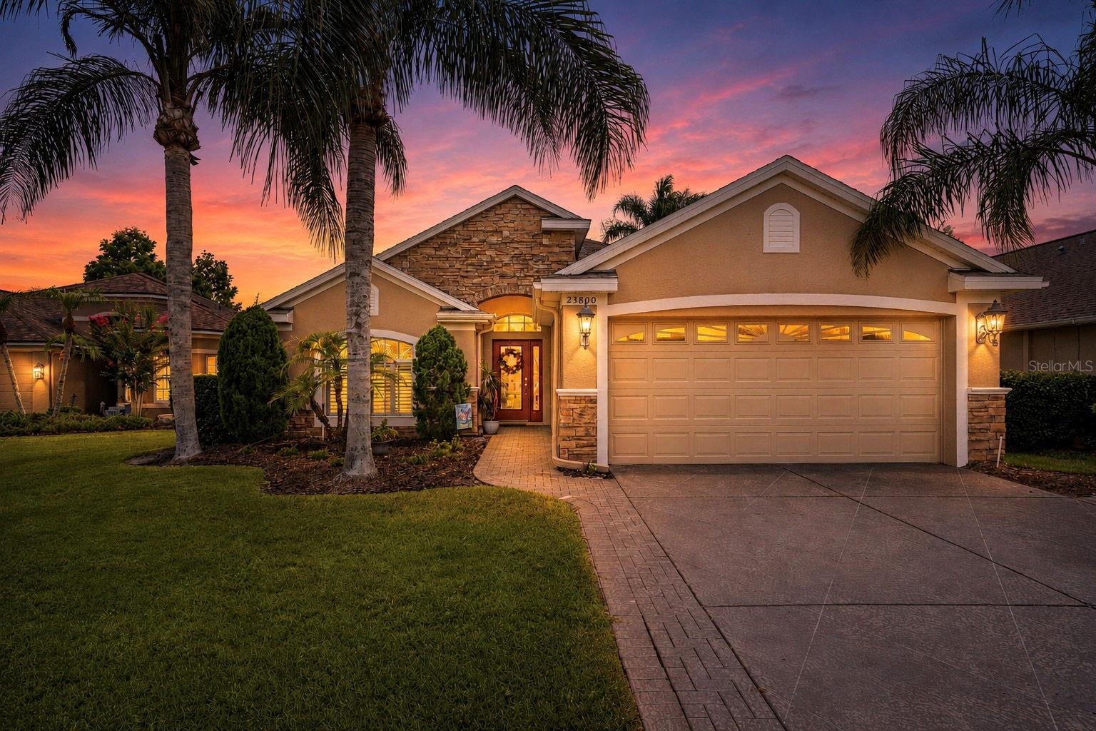 Welcome to this beautiful and move in ready home in the highly desirable Golf Course community of Plantation Palms! 3 bedrooms + designated office/den + 2 bathrooms + 2 car garage + In ground hot tub + backyard golf course AND pond views... this home as it all! Sitting on the 14th green as well as a quiet cul de sac, this home welcomes you with stone accents and impeccable landscaping. As you walk inside, you are greeted with tons of natural lighting and warm natural tones. The kitchen and living room were built cohesively, offering a great space for entertaining. Enjoy cooking in this charming kitchen that features dark wood cabinets, a 2 tiered island, stainless steel appliances, a pantry, and a breakfast nook. The living room has custom shelving that surround the entertainment area. Enjoy a formal living room for family dinners! The primary bedroom has beautiful pond and golf course views, and offers an en suite bathroom - fully equipped with a stand up shower, soaking tub, double vanities, and a large walk in closet. Both guest bedrooms are of ample size, and the guest bathroom has a shower/tub combo. This home has a designated office space, which can also be used as a den or an easy conversion to a 4th bedroom if needed! Enjoy your private backyard on the covered screened in porch, with a custom in-ground hot tub and a stunning stone water feature. Well manicured hedges give ample privacy while relaxing in the hot tub, but without taking away from the amazing views! Additional upgrades for this home include: Roof replaced in 2020, brand new water heater, new hot tub pump, and plantation shutters throughout. This home sits in a NON-flood zone so flood insurance is not required! This gated community has a low HOA and includes so many optional memberships including social clubs and golf memberships! 18 hole course, driving ranges, mini golf, an Irish pub, event centers, and more are all available to residents of Plantation Palms. Option to be sold fully furnished!