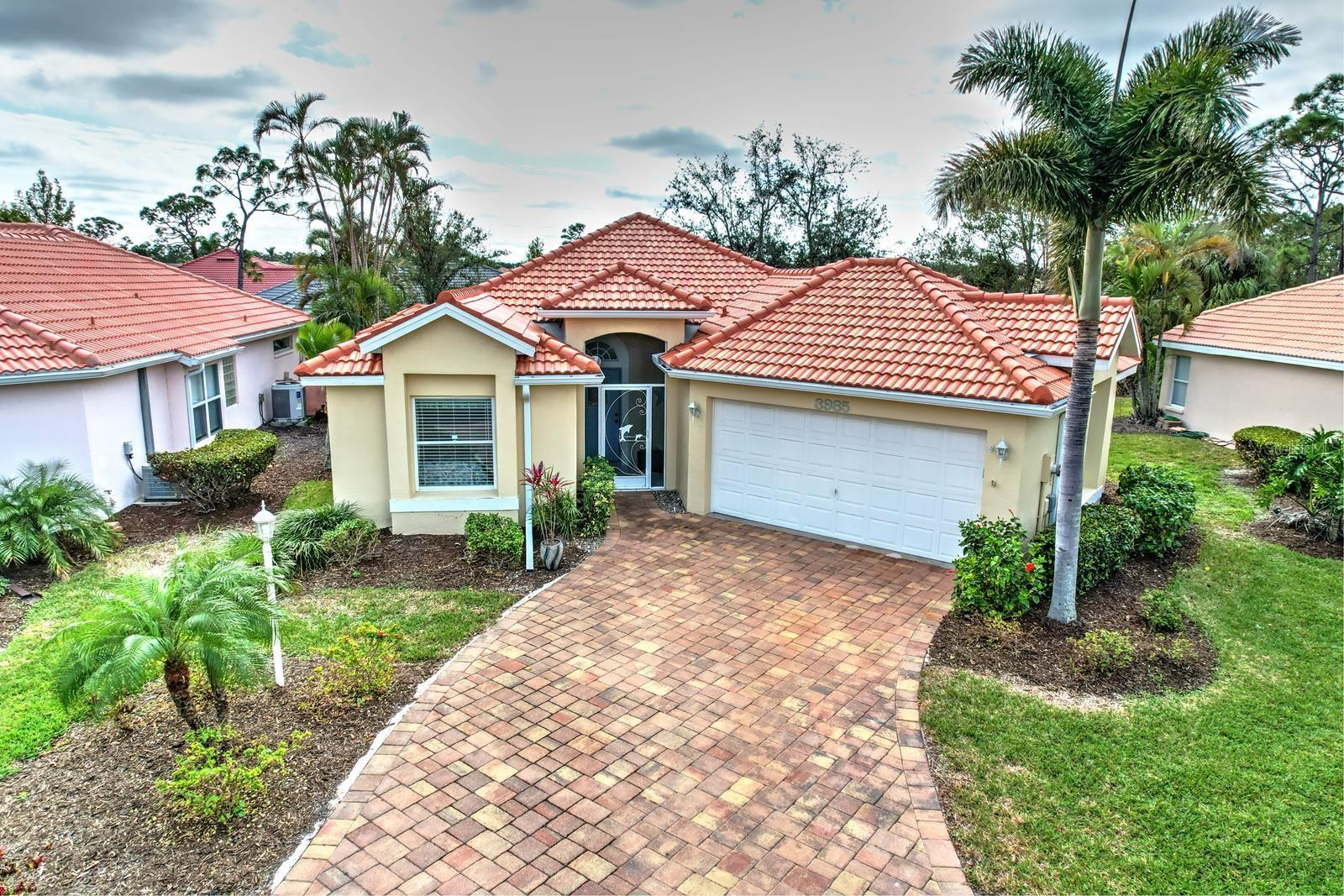 Perfectly located on a quiet cul-de-sac near the heart of the Marina, this beautifully furnished 2 bed/2 bath home offers easy Florida living with an inviting open layout and desirable southern exposure. Light and bright throughout, the home features new luxury vinyl flooring, tasteful coastal décor, and three fully pocketing sliders that open seamlessly to the spacious covered and screened lanai with peaceful landscaped views beyond. The bedrooms are on opposite sides so visiting guests have their own private wing, while the owner’s suite offers a walk-in closet, ensuite bath, and direct lanai access. The open kitchen overlooks the living area and includes a breakfast bar, abundant cabinetry, and generous prep space. Additional highlights include inside laundry, a spacious 2-car garage, new roof in January 2025, recent exterior paint, and a portable generator with transfer switch for added peace of mind in storm season. You’ll be just walking distance to the Marina, boat docks, tennis, fitness and pickleball center, with waterfront dining and Freedom Boat Club just a short golf cart ride away. Move right in and start enjoying the Florida lifestyle!
