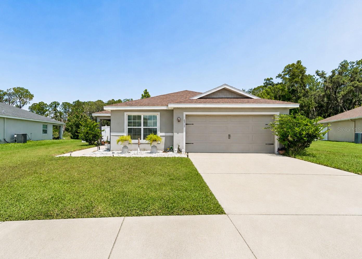 Welcome to Stonebridge at Chapel Creek! Rarely does a home with this combination of privacy, views, and outdoor space become available in this coveted neighborhood enclave. Built in 2020 and situated on a quarter-acre lot, this beautifully maintained 3-bedroom, 2-bathroom home with fully fenced-in backyard boasts offers one of the largest and most private homesites in the neighborhood, backing to a peaceful conservation area with picturesque views of the lake and wooded preserve. Enjoy the serenity from the covered patio creating the perfect setting for relaxing, entertaining, or simply enjoying nature. Inside, you'll find an open and welcoming floor plan with high vaulted ceilings and durable luxury vinyl plank flooring throughout the main living areas while the bedrooms provide added comfort with carpeting. The spacious kitchen features upgraded Samsung stainless steel appliances, a pantry and breakfast bar, with an open design for a seamless flow into the living and dining spaces - perfect for everyday living and entertaining. The primary suite offers a walk-in closet, dual-sink vanity, soaking tub, and separate shower while a thoughtful split bedroom design offers additional privacy. Additional features include an in-wall pest control system, irrigation system, and a two-car garage. Neighborhood residents enjoy access to outstanding community amenities, including a resort-style beach-entry pool, dog park, walking trails, recreation area and playground. Combining quality newer construction, an exceptional homesite, and sought-after community amenities, this home presents the perfect setting to enjoy peaceful Florida living while remaining close to shopping, dining, schools, and everyday conveniences. Call today to schedule a private showing!
