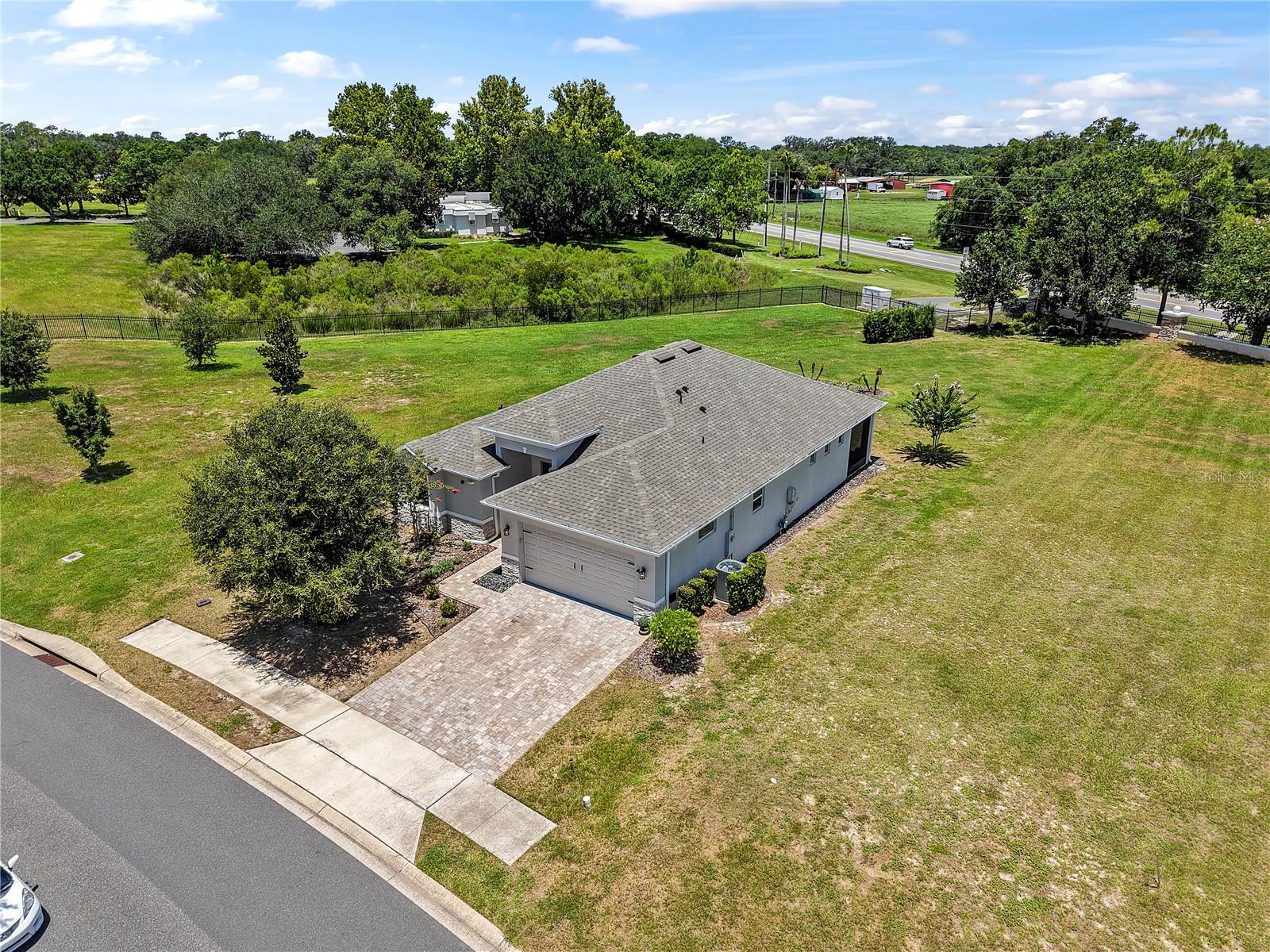 Welcome to your dream home in the highly sought-after, award-winning Lakes of Mount Dora 55+ community! Built in 2020, this stunning 3-bedroom, 2-bathroom single-family residence perfectly blends modern luxury with effortless low-maintenance living. HOA Property to the west side of the house and there will be no Neighbor.

Boasting an expansive open-floor plan with high ceilings, recessed tray lighting, and gorgeous laminate flooring throughout the main living areas, this home feels exceptionally bright and airy. The gourmet chef's kitchen features sleek custom cabinetry, a massive statement island with built-in seating, stainless steel appliances, a range hood, and double wall ovens—perfect for entertaining. Dropping in their brand new 2025 Roof!

The primary suite is a true retreat, offering a spacious layout, an incredible oversized custom walk-in closet with built-in organizers, and a spa-like en-suite bath with a large walk-in shower. A beautifully accented barn door adds a touch of modern farmhouse charm to the layout. Step out onto your private, screened-in back patio overlooking an expansive, beautifully landscaped 0.32-acre lot with no direct rear neighbors, providing ultimate privacy and peaceful views. Complete with a 2-car garage and premium finishes inside and out, this vacant, turn-key home is ready for you to move right in and start enjoying the resort-style amenities of Mount Dora!