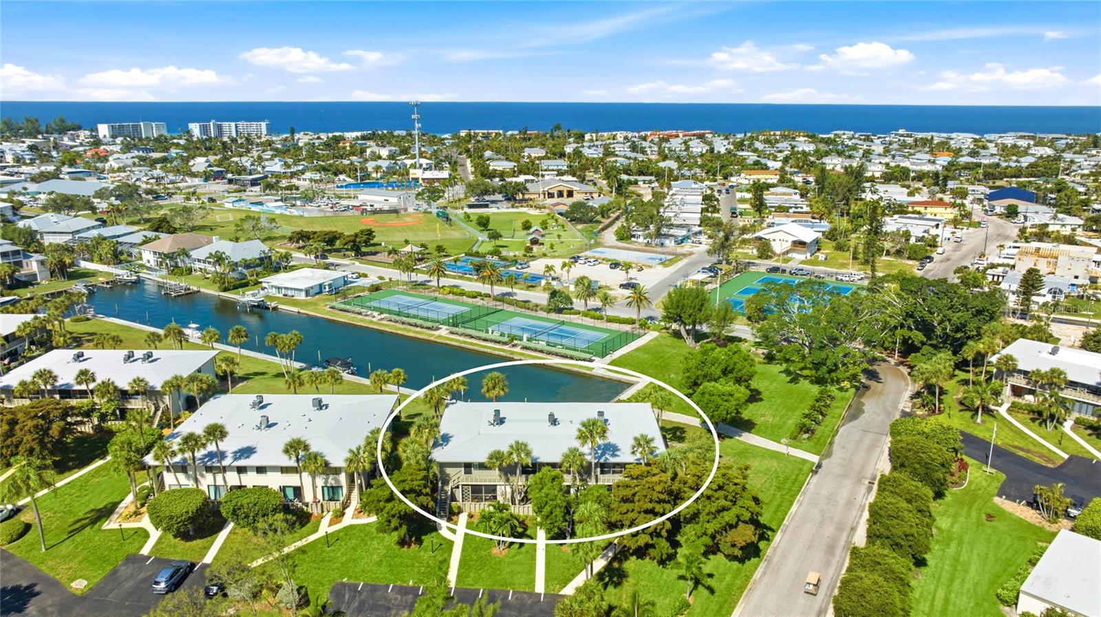 No Storm damage or flooding from hurricanes! Beautifully updated and fully furnished, this second-floor waterfront condo in Westbay Point & Moorings is one of the few units in the community to include both a DEEDED BOAT SLIP and a PRIVATE CARPORT. Enjoy your morning coffee or evening sunsets from the west-facing enclosed lanai overlooking the canal and your boat slip. The spacious floor plan offers two large bedrooms, each with its own private bath, along with generous closet space throughout. A separate utility closet on the screened front lanai includes the stackable washer and dryer and provides extra storage. Whether you enjoy fishing from the dock, taking your golf cart around the island, or heading out by boat for a day on the Intracoastal Waterway and Tampa Bay, this condo makes it easy to enjoy the Florida lifestyle. The updated interior features granite countertops, wood-look ceramic tile flooring, modern appliances, and quality finishes throughout. Remote-controlled electric hurricane shutters on the rear lanai and accordion shutters on the front provide added protection and peace of mind. Westbay Point & Moorings is a well-maintained waterfront community with an on-site manager, low condo fees, and a quiet location in the heart of Holmes Beach. You're within walking distance of the beach, local parks, restaurants, and shopping. Whether you're looking for a full-time residence, a seasonal getaway, or an investment opportunity, this condo offers excellent flexibility. Rentals are permitted with a 30-day minimum, giving you the option to generate rental income when you're not enjoying it yourself!