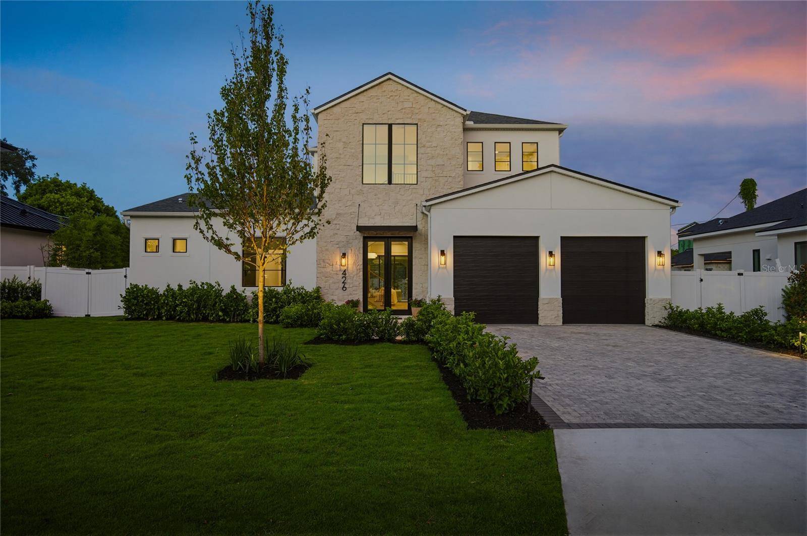 Nestled within the highly sought-after Kenilworth Shores neighborhood, this extraordinary new construction home represents a rare opportunity to own one of Winter Park's finest new builds. Thoughtfully designed with an exceptional floor plan and uncompromising level of craftsmanship, detail, and finishes. This home is located just minutes from everything Winter Park has to offer. Step through the front doors into a breathtaking two-story foyer where soaring ceilings, and a statement chandelier create an unforgettable first impression. Designed for both everyday living and effortless entertaining, the floor plan is one of the home's most desirable features. Rare for Winter Park, the residence offers a luxurious primary suite, private guest suite, and dedicated office all on the main level. The expansive living room serves as the heart of the home, showcasing extensive custom trim work, an electric fireplace, and bespoke built-in cabinetry with LED underlighting. Walls of glass create a seamless connection to the outdoor living spaces while filling the home with natural light. The chef's kitchen is a true showpiece, designed to satisfy even the most discerning culinary enthusiast, featuring stunning Calacatta quartz countertops, custom cabinetry, a paneled built-in refrigerator, and a complete suite of Thermador appliances. Adjacent to the kitchen, the formal dining room creates an elegant setting for entertaining, featuring a custom dry bar complete with a wine refrigerator. Privately tucked away, the primary suite serves as a true retreat, featuring sliding glass doors leading directly to the backyard oasis, creating a seamless indoor-outdoor connection. The spa-inspired primary bath features marble mosaic tile, floating mirrors above dual vanities, a freestanding soaking tub, an oversized walk-in shower, and a generous walk-in closet. The upper level continues the home's thoughtful design with a spacious loft, accompanied by three generously sized bedrooms. Outdoor living is equally impressive, a covered lanai creates the perfect setting for year-round entertaining and is fully equipped with a summer kitchen. The beautifully designed backyard retreat showcases a sparkling pool and spa surrounded by lush green space, offering the ideal balance of recreation, relaxation, and privacy. Perfectly positioned in the heart of Winter Park, residents enjoy tree-lined streets while remaining just a golf-cart ride from the boutiques, award-winning restaurants, and cafés, of Park Avenue. The home is also conveniently located near Winter Park High School, Advent Health Winter Park, and the beloved Cady Way Park, where tennis courts, soccer fields, baseball fields, walking trails create one of Central Florida's most desirable active lifestyles. Don't miss out on this amazing new home!