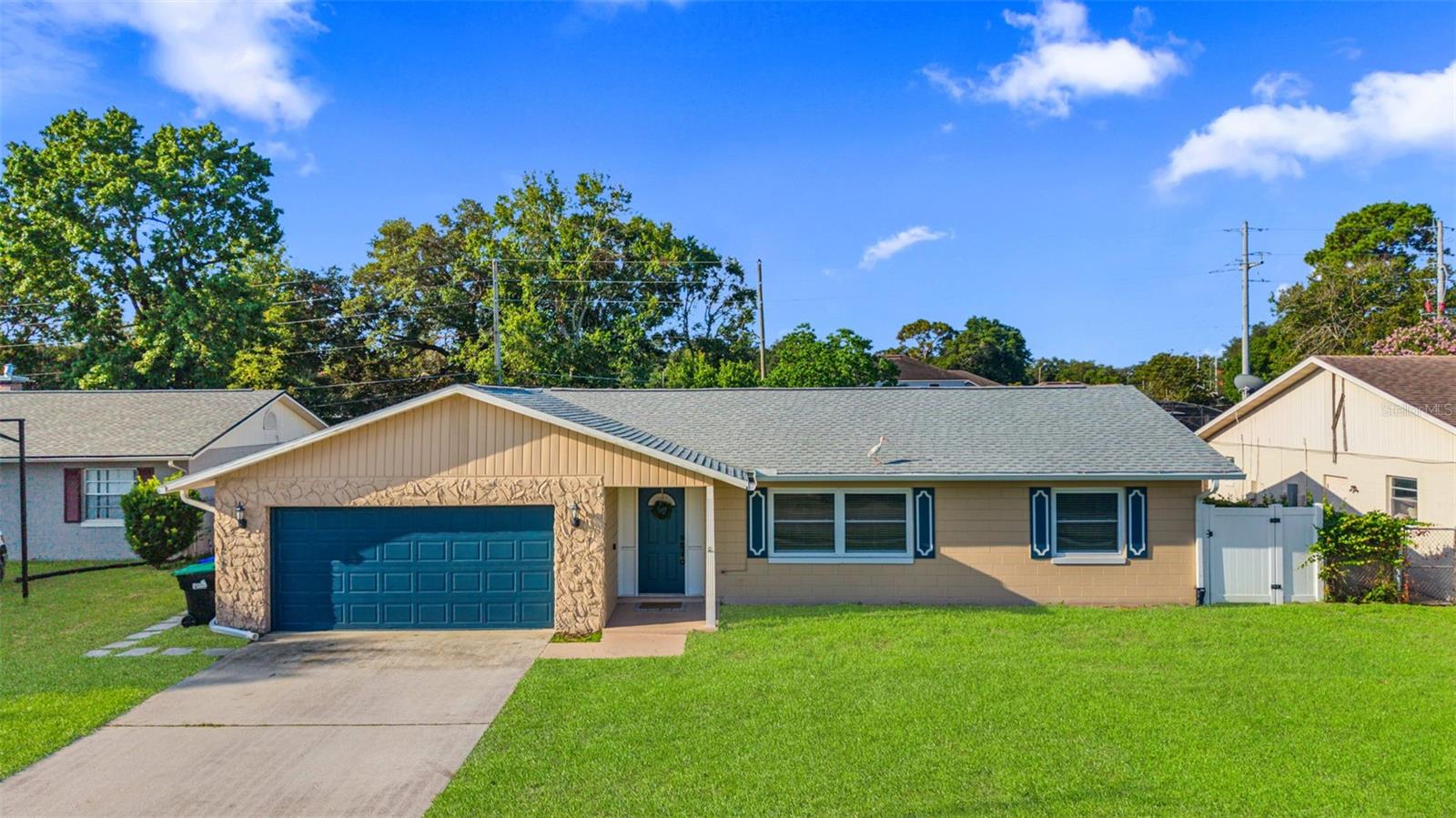 Virtually Staged. **NO HOA** FULLY UPDATED** IN-LAW SUITE** INCOME POTENTIAL** Welcome to this beautifully renovated 5-bedroom, 3-bathroom home in the heart of East Orlando, where modern design, quality craftsmanship, and versatile living come together. Situated on a spacious lot with NO HOA, this move-in ready home offers over 2,000 square feet of thoughtfully designed living space featuring luxury vinyl plank flooring throughout, creating a seamless, stylish, and low-maintenance interior.

At the heart of the home is a stunning designer kitchen that is sure to impress. Enjoy an abundance of custom white shaker cabinetry with extended upper cabinets for additional storage, elegant quartz countertops, stainless steel appliances, recessed lighting, modern hardware, and a spacious peninsula with bar seating that flows effortlessly into the open living and dining areas—perfect for entertaining or everyday living.

The luxurious primary suite serves as a private retreat, highlighted by a spa-inspired ensuite bathroom featuring an oversized walk-in shower with floor-to-ceiling marble-look tile, frameless glass enclosure, built-in bench, rainfall shower head, designer lighting, premium fixtures, and a custom dual-sink vanity with quartz countertops. The additional bathrooms have also been beautifully renovated with modern vanities, contemporary tile work, stylish mirrors, upgraded lighting, and high-end finishes that give the home a custom feel throughout.

One of the home's most desirable features is the private in-law suite with its own separate entrance, kitchenette, and full bathroom, making it an incredible opportunity for multigenerational living, guest accommodations, a private home office, or rental income. Whether you're housing extended family or looking to offset your mortgage, this flexible floor plan provides endless possibilities.

Step outside to your fully fenced backyard, offering exceptional privacy and plenty of room for entertaining, pets, play, gardening, or even adding a future pool. Major updates provide peace of mind, including a new roof (2023), new gutters (2023), water heater (2025), and A/C (2015), allowing you to move in with confidence.

Conveniently located just minutes from Waterford Lakes Town Center, UCF, Valencia College, Orlando International Airport, SR-408, SR-417, shopping, dining, and major employers, this home combines modern living with an unbeatable location.

Homes with this level of renovation, flexible living options, and investment potential rarely become available. Schedule your private tour today and experience everything this exceptional property has to offer before it's gone!