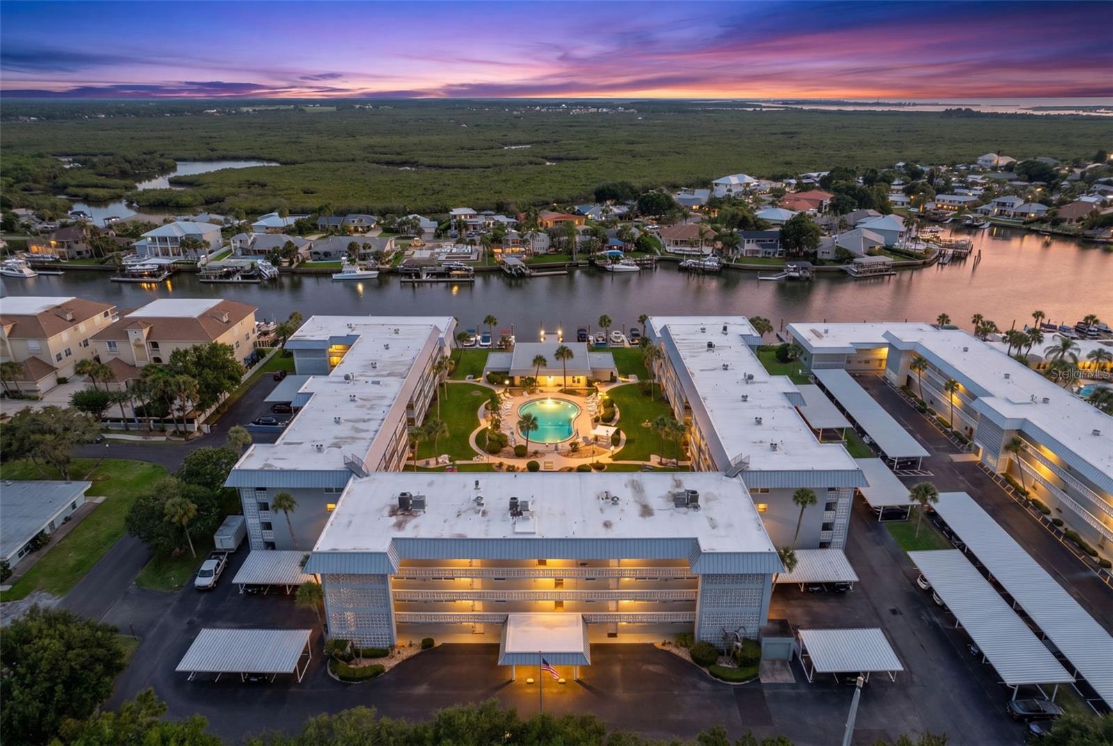 This is a chance of a lifetime to own a TOP FLOOR UNIT with views of the INTERCOSTAL in one of the most prestigious condominiums in New Smyrna Beach! This 2 bedroom, 2 full bath condo with screened in balcony (complete with HURRICANE SHUTTERS) overlooking the pool and recreational amenities is ready to come alive for its new owners. This particular unit comes with bonuses that not all other units have! Enjoy your reserved concrete block and insulated one-car garage with extra storage space. This is a MAJOR UPGRADE to the metal covered parking areas that most units come with. Additional storage space is provided for all the beach toys. The minimal condo fees provide a plethora of things to do and amenities to enjoy. The pool is considered one of the best in New Smyrna, and it's surrounded by various game courts (mini golf, shuffleboard, etc.) The complex also features a workshop for those who like to tinker! The clubhouse is spacious and features a pool table room, ping-pong, plus a kitchen and large lounge and entertainment areas. A very nice deck and dock make a great place to sit and watch the boats go by as they head out into the ocean.  Condominium updates include new plumbing, roof, and newly renovated balconies. All of this is just golf-cart driving distance to famous Flagler Ave and public beach access. It's also just around the corner from historic downtown New Smyrna Beach and all the night life and activities that makes NSB a favorite destination! Watch the videos for a better view of what this unit and Waterway West has to offer!