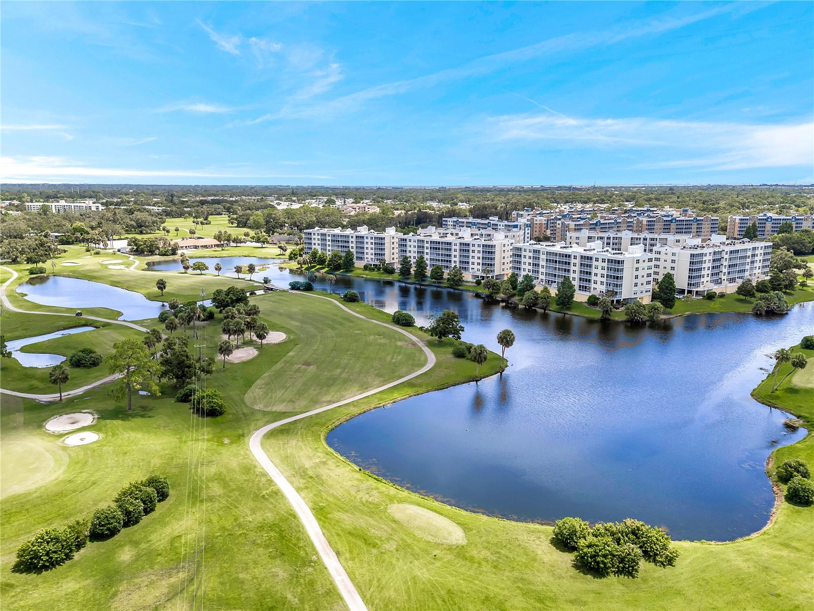 ____________________________________________________________________________________________________________________ HERE is a HIGH-VALUE yet LOW-PRICE and LOW-MAINTENANCE relaxing LOW-STRESS lifestyle. This totally BEAUTIFUL luxury condominium residence has stunning lake front and green space views - within one of the best-kept-secret communities around. Country Club Condominiums is meticulously maintained - #2205 is uniquely upgraded, updated and turnkey ready for move-in. The views are breathtaking 24 hrs a day - over tranquil lakes, lush golf course fairways & greens, palms & pine trees - making many picturesque peaceful private evenings with skies ablaze sunsets. MUCH MORE than just a place to live - enjoy this private oasis and a life of convenience, comfort, tranquility in one of Pinellas County’s most desirable locations.  
___________________________________________________________________________________________________________________
Seamless tile flooring flows through the main living areas while elegant crown molding and high ceilings provide a luxurious touch. Retreat to the primary suite, a sanctuary of comfort that includes two spacious walk-in closets and a luxurious en-suite bathroom featuring dual sinks, two walk-in closets and oversized shower. The private screened lanai is accessed from living room or main bedroom as a perfect escape for morning coffee or evening relaxation. The kitchen is equipped with a newer dishwasher, newer refrigerator, and convenient closet pantry for storage needs. A custom-built office desk beneath a wide window with pool views is an exclusive feature. In all, 1,460 total sq ft of quality living space including lanai; 2-bedrooms and 2-bathrooms; 1,324 sq ft air conditioned - by a 4 year new A/C unit. Also 4 year new water heater - newer screen door - freshly painted interior completed in 2024 (also just completed exterior painted Building Two) - dedicated laundry closet with washer and dryer included for effortless convenience - personal reserved parking next to the elevator and mailbox ensuring quick and easy access.      
____________________________________________________________________________________________________________________
Country Club Condominiums are elevated and located in a non-evacuation zone; BUILDING 2 is in great shape, well designed & built & maintained & managed , safe & strong, high & dry - without structural Milestone nor SIRS worries.  The pro-active HOA Board oversees well funded reserves, creating stability, investment value and peace of mind FOR ALL OWNERS.  The heated pool with spa and remodeled resort-style clubhouse complete with full kitchen, meeting room, library, cozy lounge area for gatherings is just steps away. The reasonable HOA fee of $672/month covers a lot - water, trash, sewer, cable, internet, WiFi, amenities, building insurances, maintenance of building and common elements. 
____________________________________________________________________________________________________________________
Nearby is dining, shopping, entertainment at Largo Mall or Seminole City Center. Also Medical facilities & hospitals plus everyday conveniences. St. Pete, Clearwater, Tampa Bay attractions, and Tampa International airport are just 20 to 30 minutes away. East Bay Golf Course and clubhouse is open daily just a short walk away. Just a 15 minute drive takes you to enjoy the soft white sands of the Gulf Beaches.
________________________________________