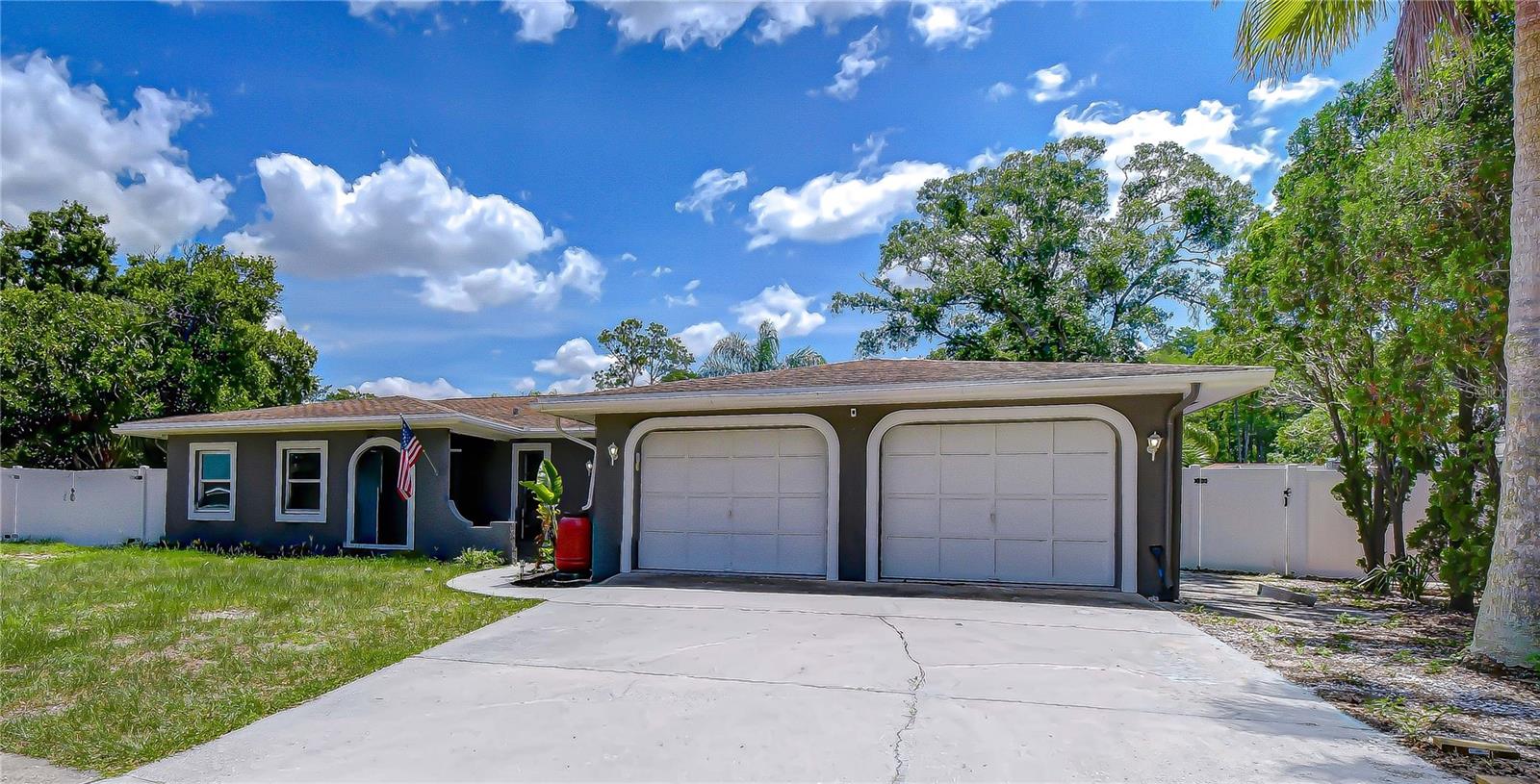 Looking for something special? You’ve found it! This beautifully maintained 4-bedroom, 3-bath pool home offers 2,304 square feet of living space on an oversized cul-de-sac lot in the desirable community of Oakleaf Village. Step inside to an open, light-filled floor plan designed for both everyday living and entertaining. The updated kitchen features granite countertops, stainless steel appliances, a center island, and seamless views of the dining and living areas. The spacious great room provides plenty of room for gathering with family and friends, while sliding glass doors open to your private outdoor oasis. Enjoy Florida living year-round in the screened-in pool area with a covered patio, perfect for relaxing or hosting guests. The oversized primary suite offers a walk-in closet and an updated en-suite bath with a granite-topped vanity and glass-enclosed walk-in shower. Two additional guest bedrooms share a full bath with dual granite vanities and a tub/shower combination. A standout feature of the home is the private in-law or teen suite, complete with a wet bar and its own en-suite bath, providing flexibility for multigenerational living, guests, or a bonus recreation space. Conveniently located near restaurants, shopping, medical facilities, St. Petersburg College Tarpon Springs Campus, and the renowned Innisbrook Golf Resort. Plus, you're just minutes from the beautiful white-sand beaches of Florida’s Gulf Coast. Schedule your private showing today and discover all this exceptional home has to offer!