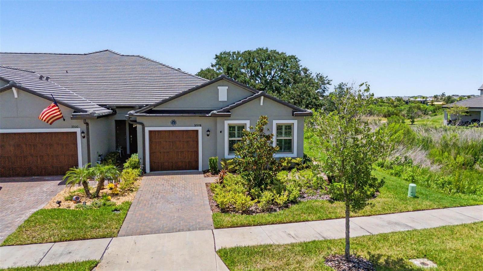 Location, Location, Location! Just steps away from the Clubhouse and Amenity Center! This END UNIT Villa surrounded by a wonderful CONSERVATION LOT in Medley Active Adult. For those better than 55 years young, presents an exceptional lifestyle just beyond the confines of your home. As a resident, you'll enjoy exclusive Clubhouse access with a full calendar of events daily! You will also enjoy a restaurant & bar, heated pool w/cabanas, ballroom, billiards room, card room, state of the art fitness center, Tiki Hut, Fire Pits, pickleball & tennis courts, bocce ball, yoga, line dancing and private active adult events. PLUS included in your HOA is a 15-acre lagoon membership w/soft, sandy beaches including a swim-up bar, kayaking, paddleboarding, obstacle course, waterslides, corn hole games, and tons of community events! Be sure & invite friends or family to come along with you as you may gift them passes or pay a deeply discounted rate! This villa will please even the most selective buyers! Comprised of 2 spacious bedrooms, 2 Full Baths + an office/den, and 1 car garage. Your new home includes lots of upgrades including WOOD SHUTTERS, quartz countertops throughout, plenty of lighting, stainless appliances and wood cabinetry. Sliding glass doors lead to your Lania with a wonderful conservation view and extra space between villas. Great spot to sit and relax and enjoy a cup of coffee or glass of wine! As you step inside, you'll be greeted by a seamless flow of open living spaces, making it ideal for both relaxation and entertaining. Get ready to make memories that will last a lifetime! Your dream home awaits; you will be enjoying the CAREFREE FLORIDA RESORT LIFESTYLE in your new home as quickly as you are able to move in! Gorgeous curb appeal on this block villa! Enjoy 42" Cabinets, and Walk-in Pantry in this gorgeous kitchen. Primary Suite includes ensuite bath, dual sinks, and Walk-in Closet to keep you organized, and ceiling fans to keep you cool. High-speed (ULTRAFI) internet, premium cable, yard maintenance & exterior painting and homeowners' insurance for structure are covered by HOA. The location of this residence is equally remarkable, situated in close proximity to premier shopping destinations, and an array of dining options, you'll find yourself immersed in a vibrant community that strikes a perfect balance between exclusivity and convenience. Ride your Golf Cart to the Clubhouse, Publix, restaurants, Farmers Market, Chick-fil-A, Banks, Starbucks, Nail Shops, and more! Close to Advent Health Hospitals, BayCare Hospital, Florida Medical Clinic, Wire Grass Mall, Tampa Premium Outlet Mall, Krate at the Grove, Sam's Club, Costco, Golf Courses & Movie Theater. Easy access to I75, 275
