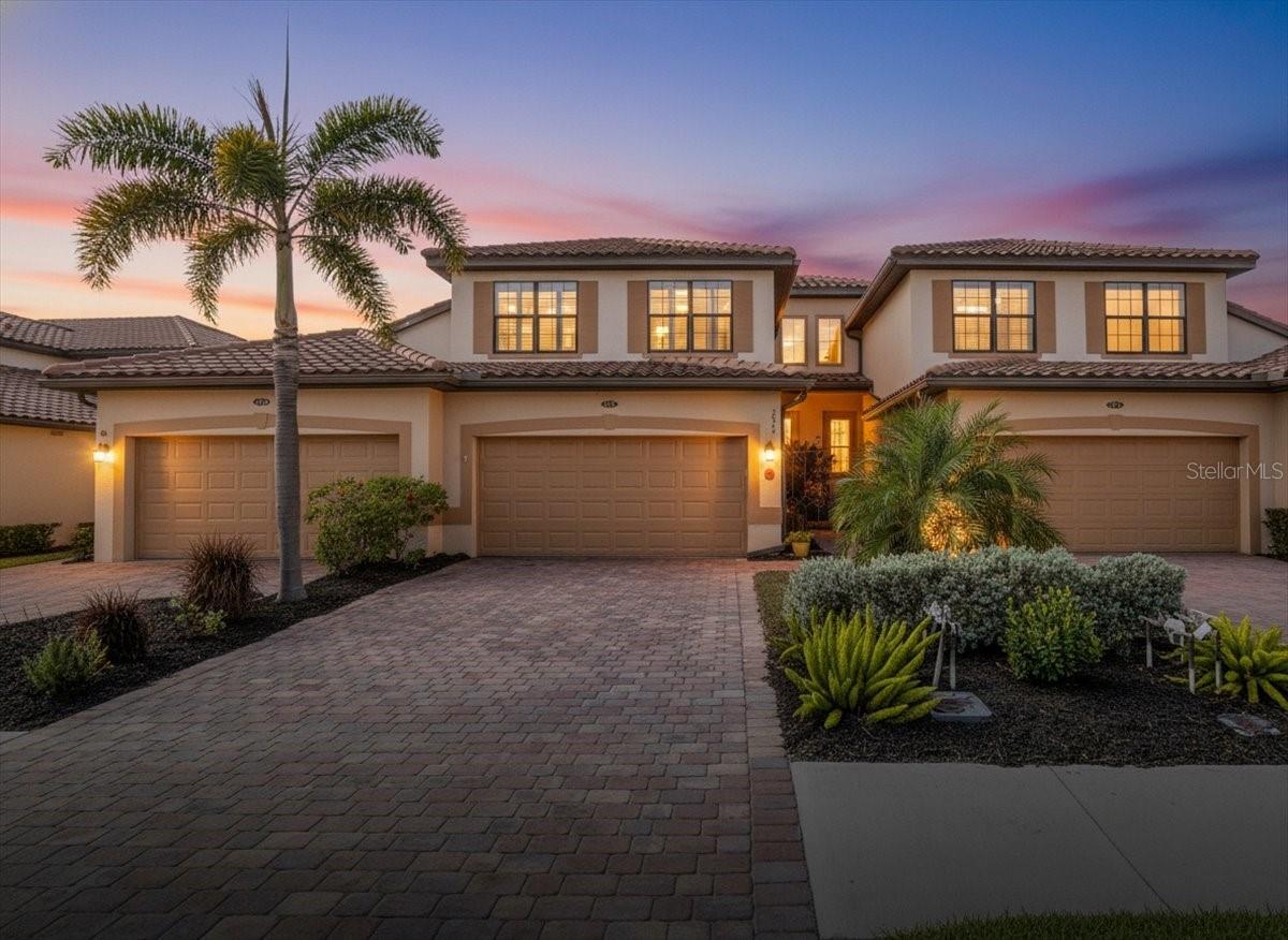 Welcome to this well-maintained Oleander Coach Home in the gated Gran Paradiso community of Wellen Park, where custom woodwork upgrades and thoughtful finishes make this residence truly special. With serene water views and 2,187 sq. ft. of living space under air, this home offers a spacious layout designed for comfort and easy Florida living.
The interior features high ceilings, tile flooring throughout the main living areas (bedrooms carpeted), luxury crown molding, custom trim, plantation shutters, and a built-in electric fireplace with stone surround. The open living and dining areas flow seamlessly into the well-equipped kitchen, which offers stainless steel appliances, granite countertops, solid wood 42” cabinets with crown molding, under-cabinet lighting, breakfast bar, and a custom breakfast nook with built-in bench seating and storage included in the sale. A coffered ceiling enhances the dining area, adding an elegant touch.
The expansive lanai overlooks tranquil water views, providing the perfect setting to relax and enjoy Florida wildlife. The spacious primary suite accommodates a sitting area, his-and-hers walk-in closets, and an en-suite bath with dual sinks, walk-in shower, and soaking tub. A split floor plan separates the guest wing, featuring two additional bedrooms, a full bath, and a full laundry room. A chair lift is installed along the front stairwell for convenience if desired.
The oversized two-car garage offers additional space for a golf cart, workshop, or hobby area—effectively a 2.5-car garage. Gran Paradiso amenities include a resort-style pool and spa, fitness center, tennis and pickleball courts, walking trails, clubhouse, and a full-time activities director. Ideally located in Wellen Park near shopping, dining, entertainment, CoolToday Park (the Spring Training home of the Atlanta Braves), and nearby beaches, with a newly built Costco Warehouse just minutes away. Schedule your private showing today. Sellers are ready to move!