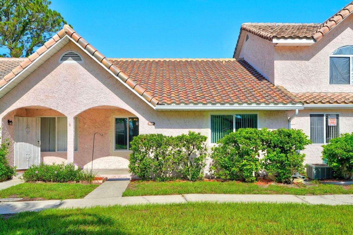 Under contract-accepting backup offers. Move right into this beautifully maintained one-level townhome offering the perfect blend of comfort, convenience, and low-maintenance living. This spacious 2-bedroom, 2-bath home features an open and airy layout with vaulted ceilings that create a bright, welcoming feel throughout the main living areas. Enjoy easy-care tile and laminate flooring throughout, combining durability with stylish appeal. The functional floor plan offers comfortable bedrooms, well-appointed bathrooms, and seamless indoor-outdoor living designed for easy everyday living.

Step outside to the oversized screened porch, perfect for morning coffee, relaxing evenings, or entertaining guests. The porch also includes additional storage and laundry hookups for added convenience. The rear yard offers extra outdoor space with the option to be privately fenced, creating an ideal space for pets, gardening, or added privacy.

This home also features a durable tile roof, two dedicated parking spaces, and convenient guest parking for visitors.

Residents enjoy access to desirable community amenities including a community pool and clubhouse, making it easy to enjoy the Florida lifestyle year-round.

As an added bonus, the HOA is fully paid through December 31, 2026, offering exceptional value and immediate savings for the next owner. Whether you're searching for a primary residence, seasonal retreat, or low-maintenance investment property, this move-in ready townhome is an opportunity you won't want to miss.