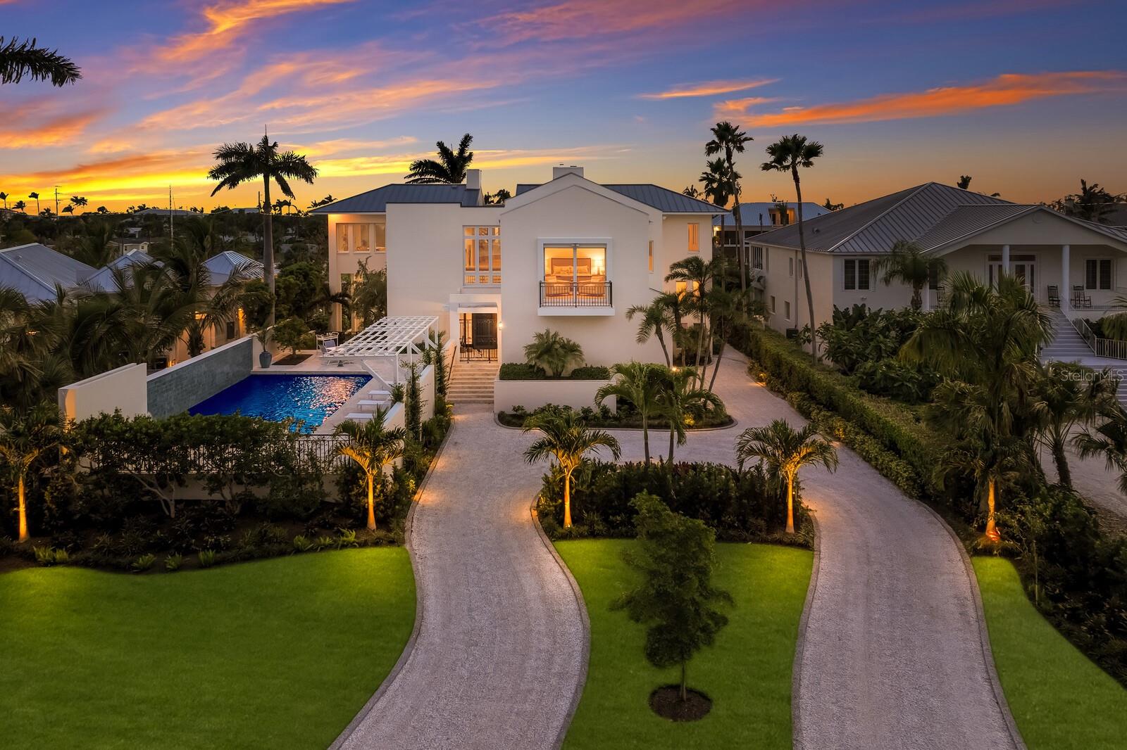 Owners of luxurious watercraft, your attention is requested! With more than 6,100 square feet of living area and 100’ of deep water dockage along the Boca Grande Bayou, this seldom found location on over HALF AN ACRE OF LAND with DIRECT ACCESS (no bridges!) to Charlotte Harbor and the Gulf of Mexico provides an exceptional value for those seeking waterfront property for a large boat in a protected location!  In contrast to typical canals in the region, the spacious Boca Grande Bayou offers effortless navigation for yachts surpassing 60’ in length.  This grand Bermuda style home designed by the Siebert Architectural firm and built by premier local builder, Giacinti Contracting, is a four bedroom, four bathroom home with two additional powder bathrooms and three-car attached garage featuring an elevator, new roof, new hot water heaters, two new HVAC systems, a resort style pool 40’ in length, and rests on more than half an acre in the private, gated community of Boca Grande Isles.  Upon entering this beautiful estate, the extended circular shell driveway is complimented by freshly landscaped tropical grounds, new exterior landscape lighting and irrigation, and provides ample parking for the finest Island soiree.  The front entry welcomes you into the grand imperial floating staircase with soaring ceilings designed to showcase your favorite artwork collection.  The primary living space is ideally located on the top floor providing elevated sweeping views of the Bayou and the western sunset sky.  Cohesively designed with gorgeous travertine floors throughout, the heart of the top floor living space is centered around a custom designed coral stone fireplace.  In addition to the kitchen, discreetly behind the fireplace is a fully equipped butler’s pantry with additional refrigerator, dishwasher, ice maker, warming drawers, and generous countertop space and storage.  The first floor of the residence features three guest ensuites each with dazzling water views centered around a cozy family room with custom designed entertainment center, built-ins, and kitchenette.  This Island residence provides the ultimate boater’s lifestyle with convenient beach access nearby and is a short distance from restaurants and shops.