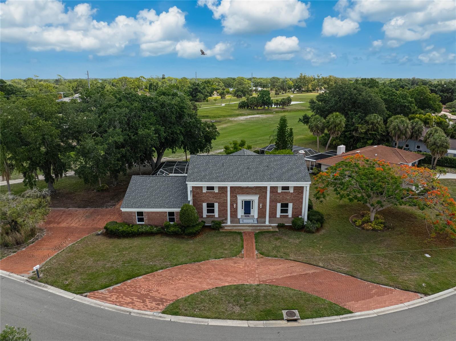 Classic Estate-Style Home with Pool & Golf Course Views!
Welcome to this stately 5-bedroom, 3.5-bath residence in Forest Lakes Country Club Estates, offering timeless curb appeal, generous living space and peaceful golf course views in the heart of Sarasota. Set on a spacious 0.37-acre lot, the home makes a lasting first impression with its classic brick-style exterior look, white columns, mature landscaping, circular brick driveway and ample parking, including additional driveway space along the side of the home. Inside, the grand two-story foyer showcases the home’s architectural character with a sweeping curved wood staircase, iron balusters, chandelier detail and elegant traditional design that sets the tone for the rest of the home. Thoughtfully refreshed, the home features a new shingle roof in 2026, fresh interior paint throughout and meaningful upstairs updates, including new LVP flooring throughout the upstairs hallway and bedroom areas. The main level features formal living and dining areas, a wood-burning fireplace and an oversized eat-in kitchen with solid wood cabinetry, pull-out storage, granite countertops, stainless steel appliances and a walk-in pantry. Designed for indoor-outdoor Florida living, sliding doors and a pass-through window connect the kitchen to the expansive covered lanai and large screened pool area, creating an ideal setting for relaxing, entertaining and enjoying the peaceful green views. The flexible floor plan also includes a family room, private office/study with exterior access and a downstairs bedroom suite with ensuite bath and private pool access, perfect for guests, extended family or multigenerational living. Upstairs, the refreshed living quarters provide room for everyone to spread out. The oversized primary suite extends from the front of the home to the back and features a walk-in closet, generous natural light and beautiful views of the golf course setting. The upstairs improvements continue with recently replaced custom bathroom vanities in all three upstairs bathrooms, new ceramic tile in both upstairs bathrooms, a new bathtub and a renovated upstairs shower completed in 2024. New windows were also installed in April 2026 in all upstairs bedrooms, along with two new downstairs front-facing windows. Additional highlights include a February 2025 water heater, two 2019 Rheem HVAC systems, pool cage installed in 2008 and rescreened in 2021 and a pool that was remarcited in 2017. Forest Lakes Country Club Estates is loved for its central Sarasota location, established neighborhood feel, larger lots and convenient access to some of the area’s best everyday amenities. From this location, you are close to shopping, dining, grocery stores, medical facilities, schools, parks, downtown Sarasota, Southside Village, Arlington Park, Gulf Gate, Siesta Key Beach and major roadways connecting you throughout Sarasota and Manatee counties. With its grand architecture, screened pool, updated roof, refreshed interior, golf course views, generous lot size and unbeatable central location, this classic Forest Lakes home offers space, character and the Sarasota lifestyle buyers are looking for. Schedule your private showing today!