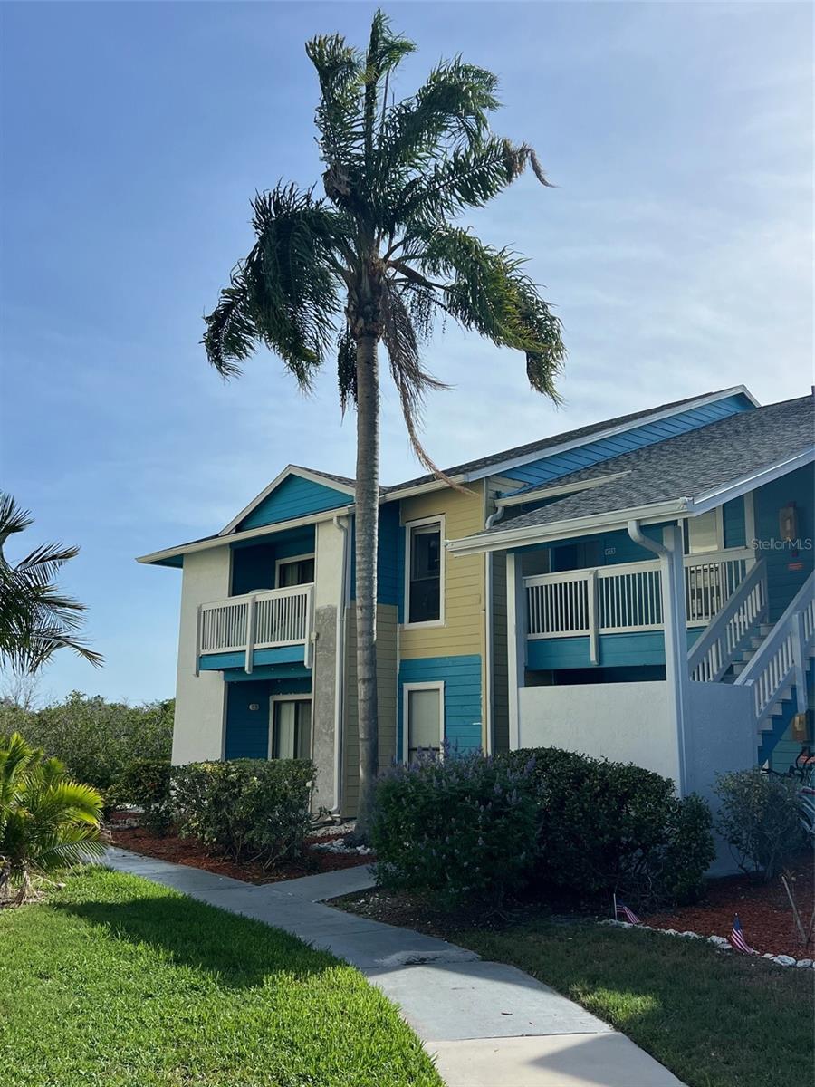 Welcome home to Harbor Club Condos, a desirable Palm Harbor condo community nestled between world famous Honeymoon Island to the south and the quaint waterfront Ozona neighborhood to the north.  Enjoy the water and conservation views as you approach the entrance to this ground floor unit.  This split-plan condo unit has two bedroom and two baths with tile floors throughout.  The kitchen features newer cabinets, granite countertops, and stainless-steel appliances, including refrigerator, stove, microwave, disposal, and dishwasher.  At the end of the kitchen you'll find a small utility closet with washer and dryer included.  The living room is spacious and has a small nook in the corner, a perfect spot to have a small office or quiet place to read.  The living room has a sliding glass door that opens to a covered porch, a perfect spot to relax and take in the nature views.  Both bathrooms have vanities with ample storage and granite countertops.  A brand-new air handler and the condenser were installed in 2024 and a new water heater was installed in 2020.  This community features two pools, a spa, tennis/pickle ball courts, and is adjacent to the Pinellas Trail, a great place to walk or bike-ride into downtown Dunedin or downtown Palm Harbor.  Harbor Club is conveniently located so close to an abundance of attractions, shops, bars, marinas, beaches, golf courses, and restaurants, including Honeymoon and Caladesi Islands, Dunedin Causeway, Ozona Blue, Speckled Trout Marina, Molly Goodhead's, Dunedin Golf Club and so much more.  Come check out this lovely condo today!