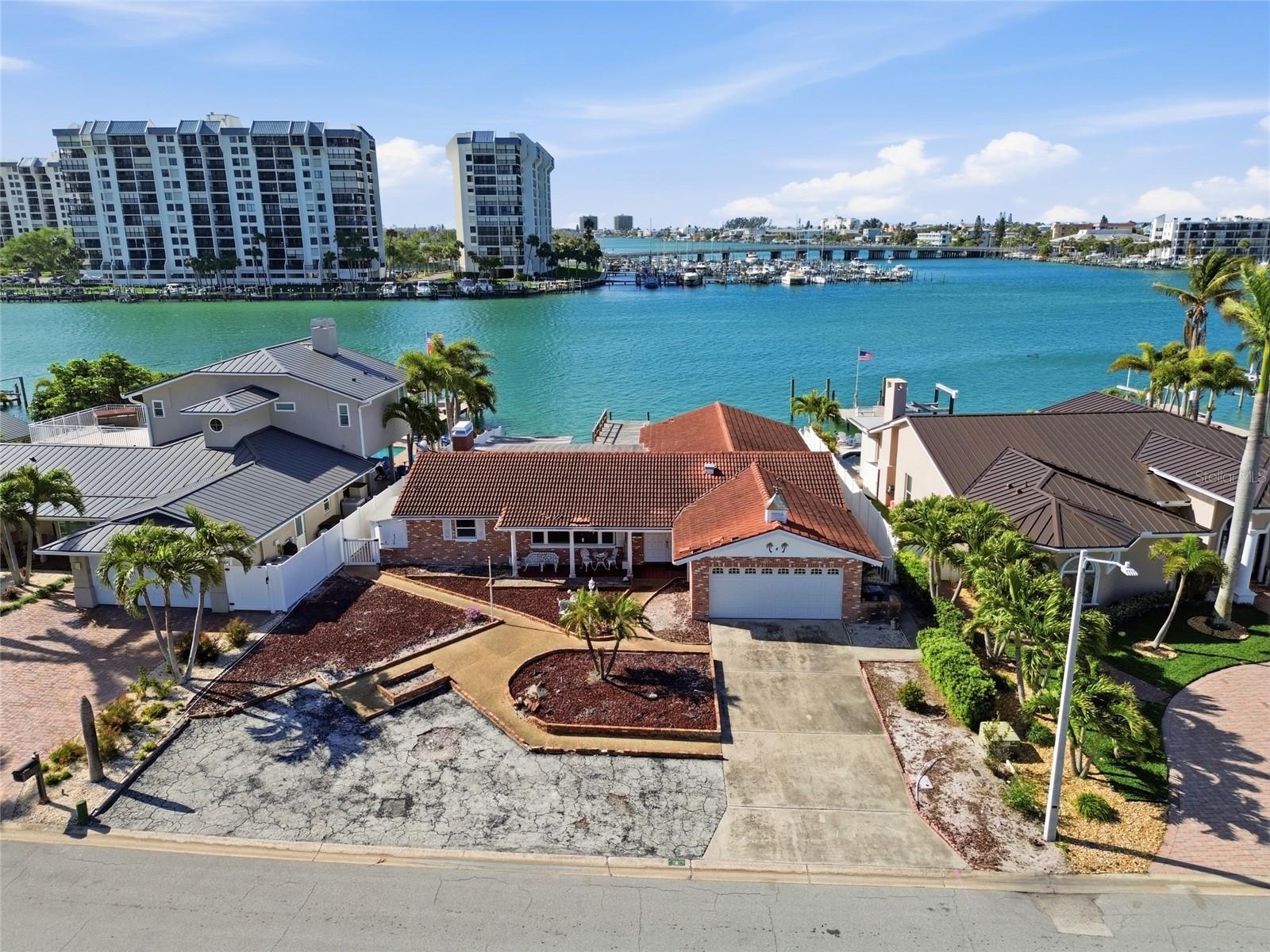 Located on a quiet cul-de-sac on Paradise Island, this 9,518 SF waterfront property with 73-feet of frontage looks south onto Devil’s Elbow with only one bridge to the Gulf. Constructed as a 2,409 SF 4-bedroom, 2-bath home, the property had 6-inches of water affect floors, drywall and electrical after hurricane in 2024 and can either be demolished or considered a rebuildable structure to build your dream home (existing neighbors have done both). Paradise Island is a highly desirable residential neighborhood known for friendly residents, convenience and tropical charm. Just minutes from the sandy beaches of Treasure Island as well as downtown St. Petersburg with its ongoing cultural events, sports and restaurants. And close by, Treasure Bay Golf & Tennis offers scenic views of Boca Ciega Bay, pickleball, tennis, a par-3 golf course (temporarily closed for an environmental study) and playgrounds—a beautiful intracoastal resource to enhance family living in Paradise Island.  Priced under 2025 appraised value.