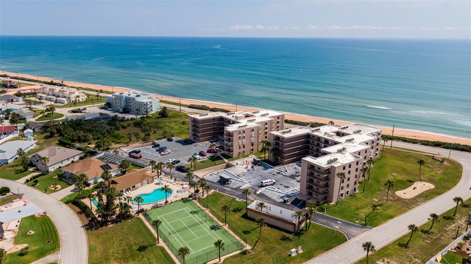 Discover effortless coastal living in this beautifully maintained ground-level oceanfront condominium, ideally situated between Flagler Beach and Daytona Beach. Offering 2 bedrooms and 2 bathrooms, this inviting residence combines comfort, convenience, and peace of mind in a setting designed for relaxed seaside living.

Inside, the unit features tile and vinyl plank flooring throughout, creating a clean, stylish look with easy maintenance. The updated kitchen is both functional and appealing, complemented by newer appliances and ample storage space that is rarely found in condominium living. A washer and dryer are also included in the unit for everyday convenience.

Step outside and enjoy direct oceanfront access with a private beach walkover, making morning strolls on the sand and sunrises over the Atlantic part of your daily routine. The community offers an exceptional lifestyle with amenities that include a pool, tennis courts, and a clubhouse, while underground parking with additional storage adds even more practicality.

This residence is built for comfort and confidence, featuring impact windows, hurricane shutters, a new roof, and a new A/C installed in 2024. The milestone inspection was also completed in 2024, offering added reassurance to future owners.

Live worry-free with an impressive list of included services, such as internet, water, sewer, trash, and exterior maintenance, all designed to make ownership simple and enjoyable.

Whether you are looking for a full-time residence, a seasonal retreat, or a low-maintenance beachfront escape, this oceanfront condominium offers the ideal blend of location, updates, amenities, and carefree living.