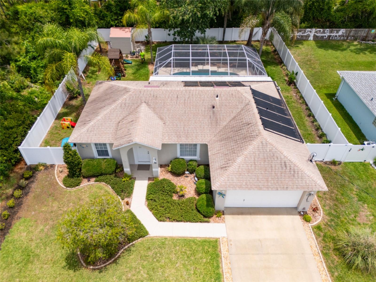 BEAUTIFULLY  maintained  3-bedroom, 2-bath BLOCK  home with a 2-car garage and NO HOA! This move-in-ready home features a popular split-bedroom floor plan, vaulted ceilings, abundant natural light, tile flooring throughout, Stainless steel appliances  and an indoor laundry room. Enjoy your own private backyard retreat with a screened in  Lanai and solar-heated POOL, surrounded by lush landscaping, white vinyl fencing,  and a storage shed. A wooded area on the right side provides added PRIVACY  with no immediate neighbors. Major updates include  ROOF (2020), HVAC(2018), and HOT WATER HEATER (2025) & NEW POOL PUMP 2023. Meticulously cared for and ready for its next owner this home is NOT in a flood zone—just bring your toothbrush!