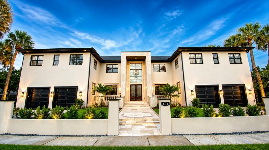 One or more photo(s) has been virtually staged. Nestled in one of Tampa's most prestigious neighborhoods, 420 S Royal Poinciana is a stunning masterpiece that embodies luxury and sophisticated living. This exquisite property transcends the ordinary, featuring a blend of modern amenities and timeless elegance. With its prime location, this residence offers an extraordinary lifestyle for discerning buyers.
Approaching the home, you are greeted by a beautifully landscaped front yard, showcasing manicured gardens with tropical plants, lush palm trees, and flowering shrubs. The elegant façade boasts a combination of natural stone and stucco, complemented by oversized windows that invite natural light into the interiors. A grand entrance with an impressive double door leads into the home.
The outdoor living space is equally breathtaking, with an impeccably landscaped backyard. The outdoor area is designed for both entertaining and relaxation.
As you step inside, the grandeur of the home is immediately evident. The foyer boasts soaring ceilings and a large chandelier, setting the tone for the luxurious atmosphere found throughout the property. High-end finishes, including marble and hardwood flooring, crown molding, and designer fixtures, enhance the sophisticated appeal of the home's interior.
The spacious family room features a fireplace and panoramic windows that provide sweeping views of the outdoor retreat. Adjacent to the living area, the formal dining room is ideal for hosting dinner parties.
The gourmet kitchen is a chef's dream, equipped with state-of-the-art appliances, including a commercial-grade refrigerator, double ovens, and a six-burner gas range. An expansive center island with a breakfast bar invites casual dining, while the custom cabinetry and elegant backsplash add a touch of luxury. The space also includes a separate butler's pantry, enhancing the functionality of the kitchen.
The home offers multiple spacious bedrooms, each of the 5 bedrooms upstairs with en-suite bathrooms and spacious closets, designed with high ceilings and large windows that bring the beauty if the outdoors inside.. The master suite serves as a private sanctuary, featuring a sitting area, luxurious spa-like bathroom with a soaking tub and a walk-in shower, and direct access to a private terrace overlooking the back yard retreat. The Bedroom downstairs has the full bathroom just outside the double door entry. 
The property includes a dedicated office, a Climate controlled room perfect for Wine/Cigar/Purse/Shoe room.  A four-car garage provides ample space for vehicles and storage. 
Located in Tampa's desirable South Tampa area, 420 S Royal Poinciana offers proximity to upscale dining, retail shops, and cultural attractions. The neighborhood is known for its vibrant community.
420 S Royal Poinciana is not just a home; it is a lifestyle. With its  prime location, this property represents the pinnacle of high-end living in Tampa, FL. Whether entertaining guests or enjoying quiet family gatherings, this residence promises an extraordinary experience for its future owners.
