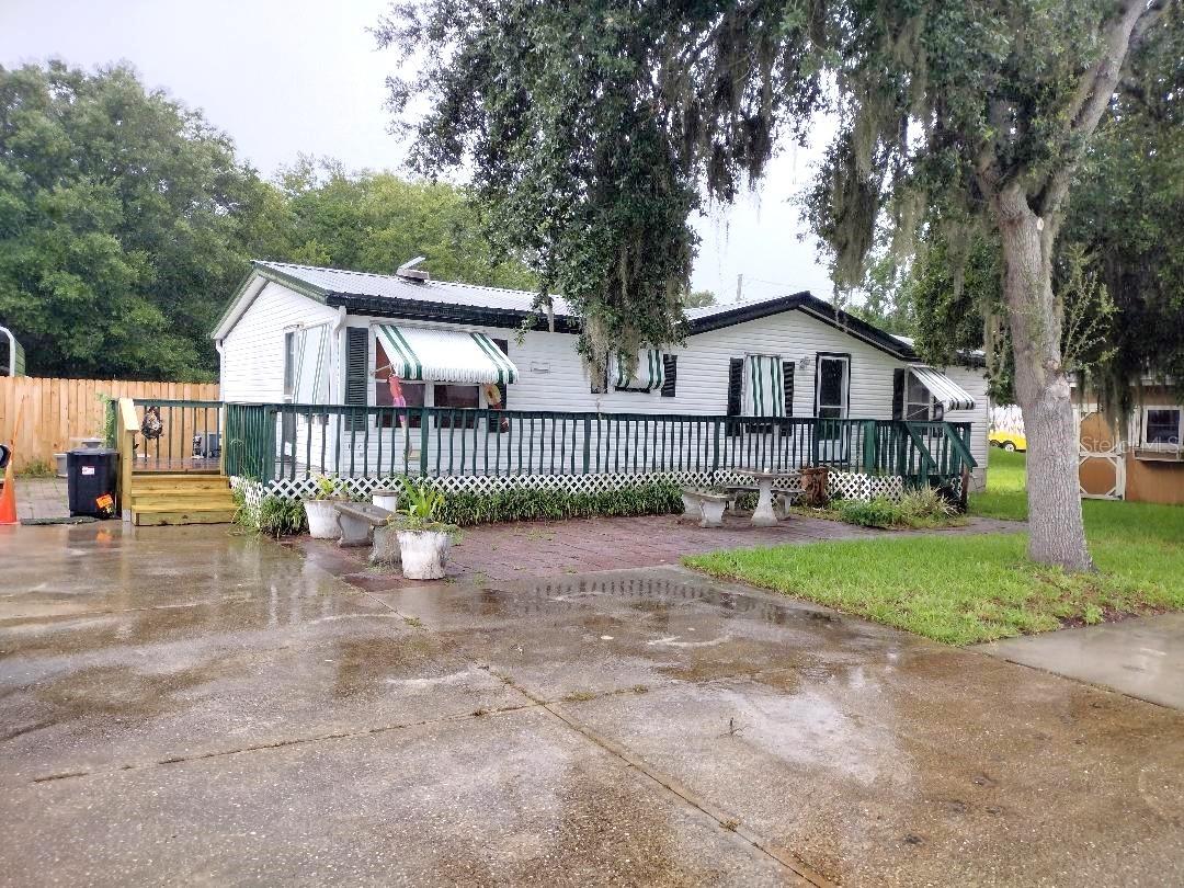 Enjoy peaceful country living in this 3-bedroom, 2-bath doublewide on a spacious 100x220' lot with paved road frontage. Features include a split-bedroom floor plan, eat-in kitchen, dining room, spacious living room, large primary suite with garden tub and separate shower, metal roof, concrete driveway, carports, storage sheds, and relaxing decks. Conveniently located about 30 minutes from the beach, shopping,
 hospitals, and I-95.  Metal roof 2013, Water Heater 2025, Termite Bond,