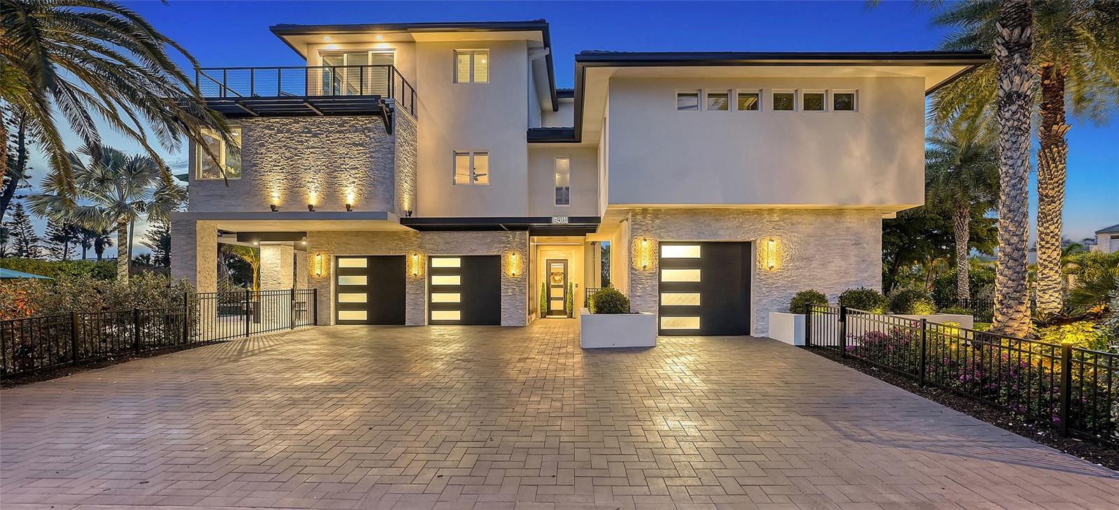 Under contract-accepting backup offers. Discover an unparalleled level of opulence and style in this extraordinary Longboat Key residence, a rare jewel recently reborn in 2022 into a modern masterpiece. Nestled on the coveted Gulf side, just steps from the beach, this custom rebuild is a testament to luxury living without compromise, where no detail has been spared and every facet, from the white oak flooring, handcrafted stone elements and LED accent lighting to the convenience of automated Hunter-Douglas Pirouette window treatments and more, reflects an unwavering commitment to excellence. Upon entry, you’ll immediately notice how meticulous craftsmanship meets sophisticated design. Ascend the in-home elevator to all levels, as the 2nd floor is designed for entertaining with a living room boasting an ambient electric fireplace, a bar with a wine refrigerator and 3 guest BRs with 3 full bathrooms. The kitchen is an absolute showplace, accentuated with sunset views over the Gulf, an oversized center island, an abundance of bespoke low-profile cabinetry including a built-in Miele coffee bar and a custom wrought iron backlit glass feature cabinet, elegant Fine Art lighting, Viking appliances including 6 burner induction stove with knobs, stately glass panels and more. French doors open to the balcony, where a bar-height table sets the scene for soirees of any size. The 3rd floor is dedicated to the primary suite, a sanctuary of tranquility with sliders out to the wraparound balcony that unveils panoramic views of the Gulf of Mexico. The master bath is a haven of indulgence, adorned with his and hers vanities and rain showers. A spiral staircase leads above to the rooftop lounge, a perfect vantage point for 360-degree views of the Gulf and bay. Venture down the spiral staircase from the main living area to a private oasis featuring a heated and chilled pool with a sun shelf and spa, and a contemporary designed covered area to watch tv or to break from the sun. The Elan/Nice smart home system adds a touch of modernity, ensuring your home is as intelligent as it is beautiful. Completing the allure are hurricane-impact windows and doors, full home generator, and the voluminous 3-car garage with abundant storage, in which the 3rd car space can be air-conditioned and repurposed as a gym or office. The property, enveloped by lush tropical landscaping, exudes an air of exclusivity, making it feel like a private resort. Bedroom Closet Type: Walk-in Closet (Primary Bedroom).